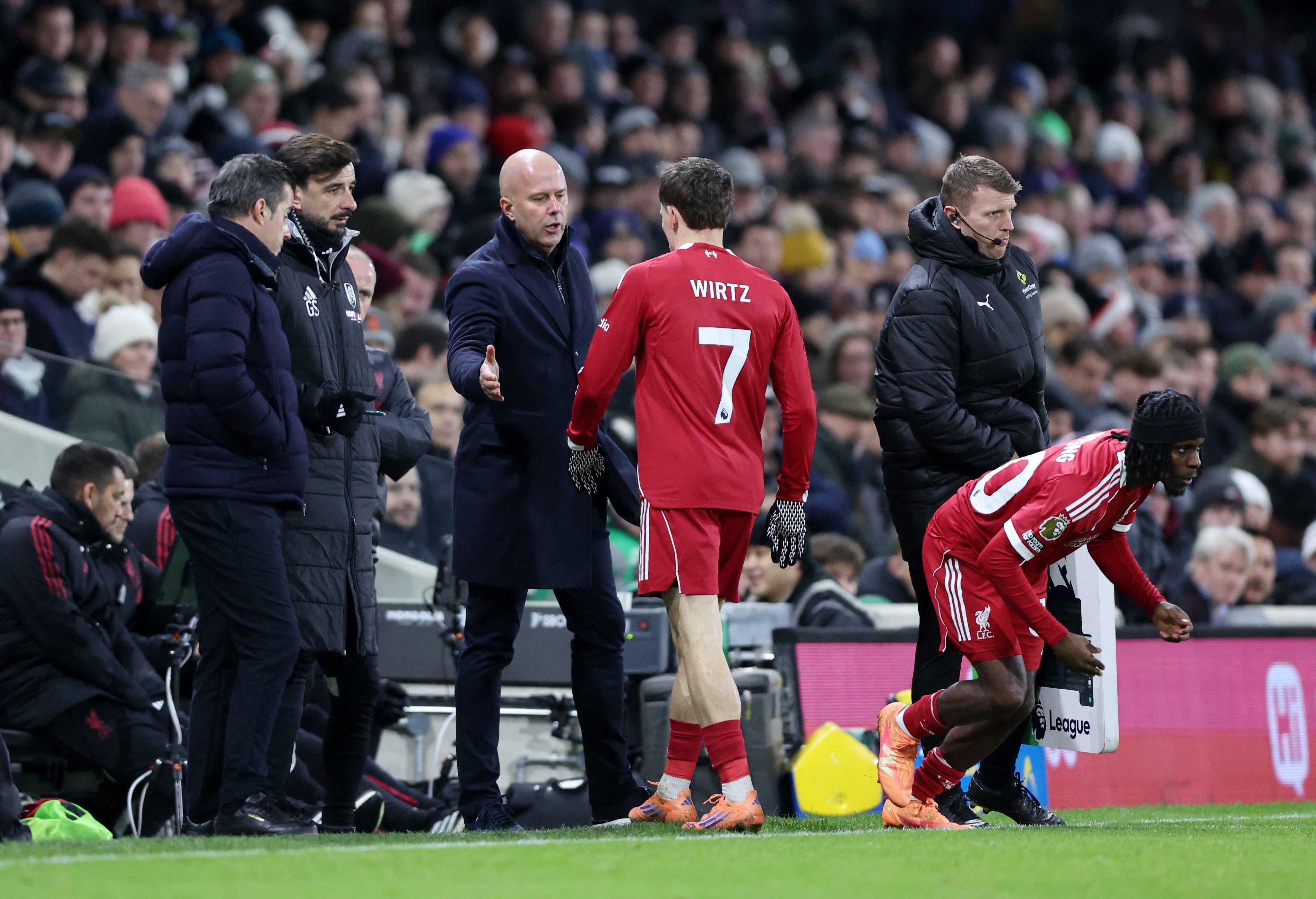 Soccer Football - Premier League - Fulham v Liverpool - Craven Cottage, London, Britain - January 4, 2026 Liverpool's Jeremie Frimpong comes on as a substitute to replace Liverpool's Florian Wirtz as Liverpool manager Arne Slot reacts REUTERS/David Klein