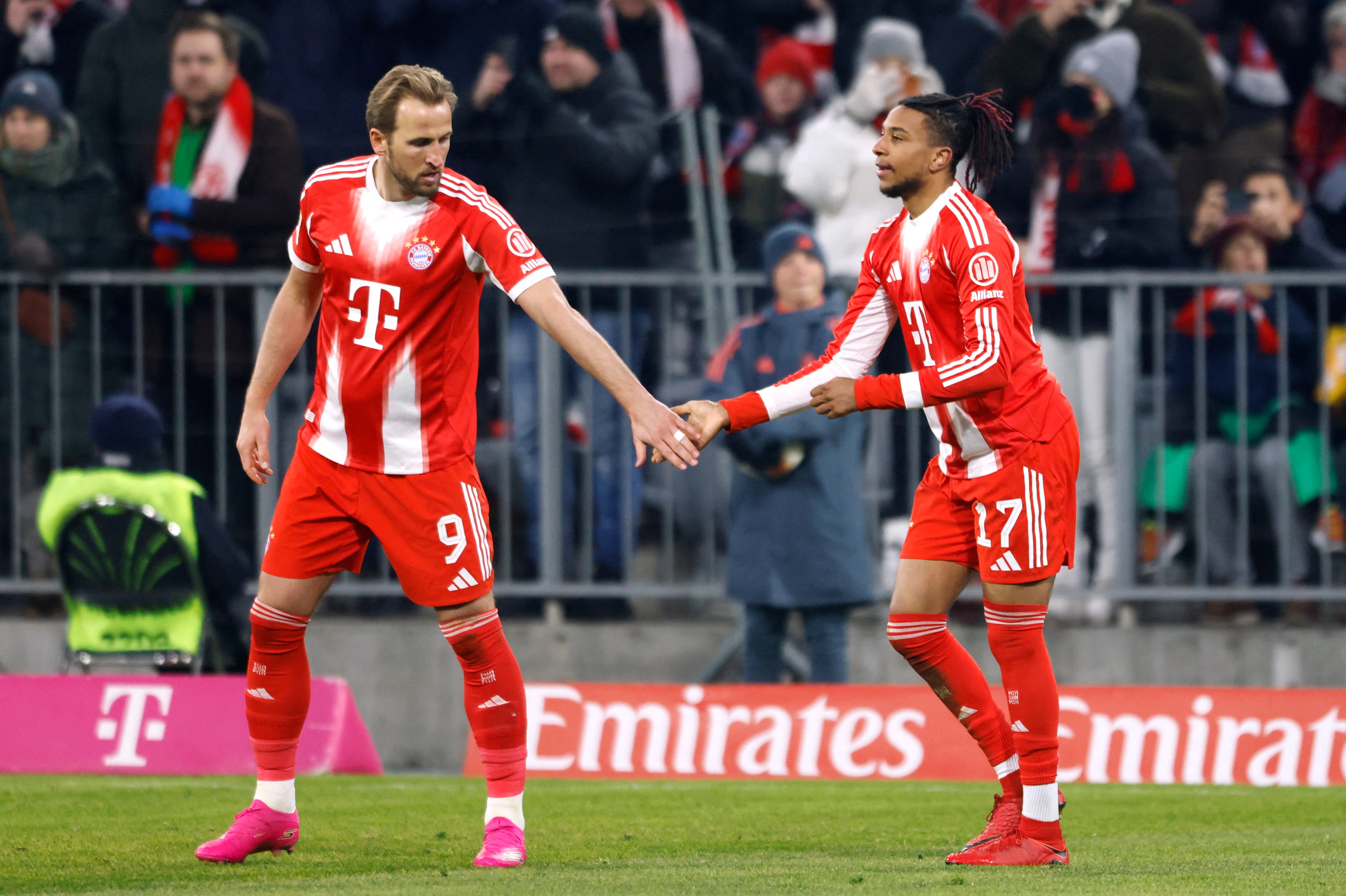 Soccer Football - Bundesliga - Bayern Munich v VfL Wolfsburg - Allianz Arena, Munich, Germany - January 11, 2026 Bayern Munich's Michael Olise celebrates scoring their third goal with Harry Kane REUTERS/Michaela Stache DFL REGULATIONS PROHIBIT ANY USE OF PHOTOGRAPHS AS IMAGE SEQUENCES AND/OR QUASI-VIDEO.