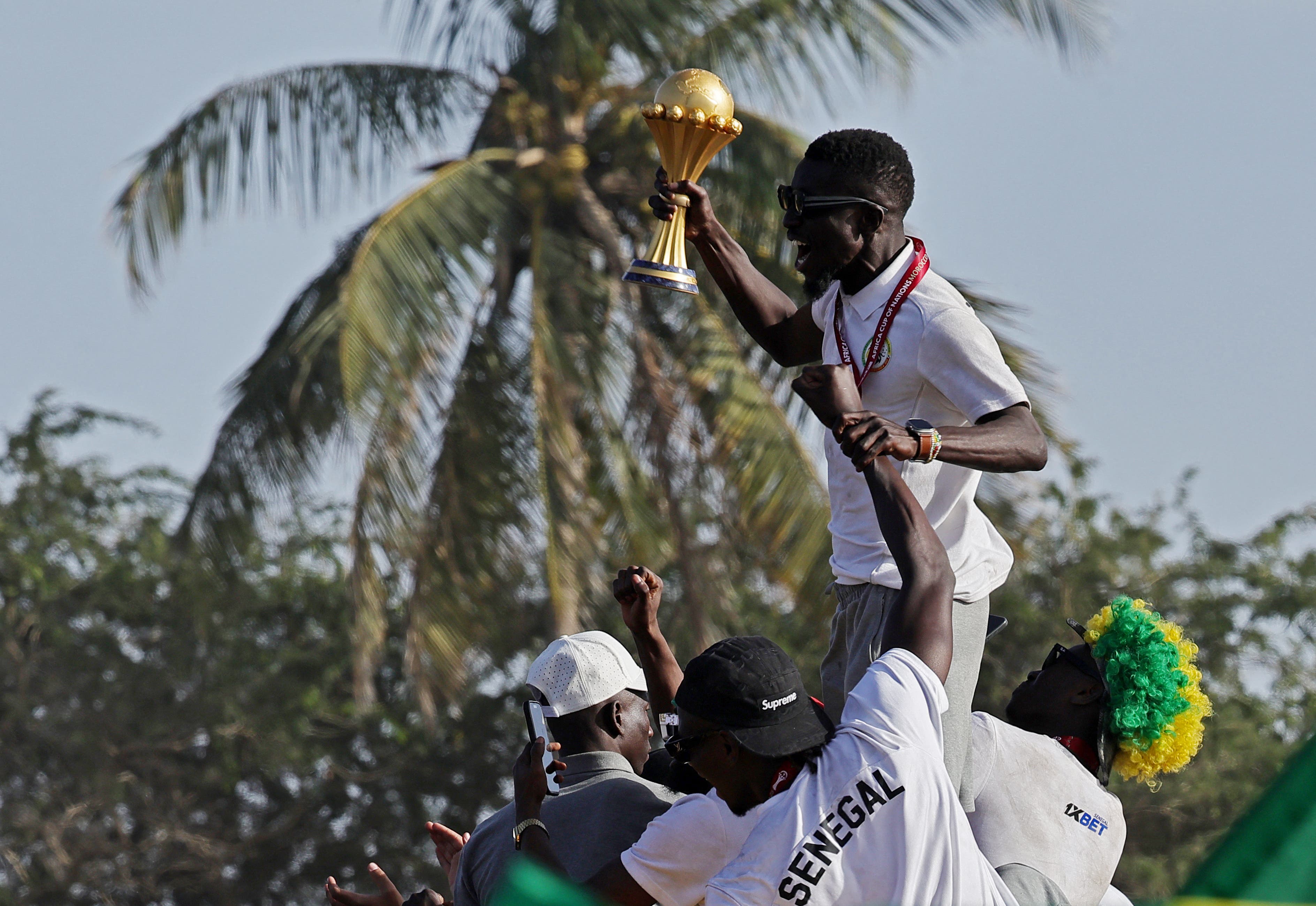 Soccer Football - CAF Africa Cup of Nations - Morocco 2025 - Final - Senegal Victory Parade - Dakar, Senegal - January 20, 2026 Senegal players celebrate with the trophy on the bus during the parade REUTERS/Zohra Bensemra