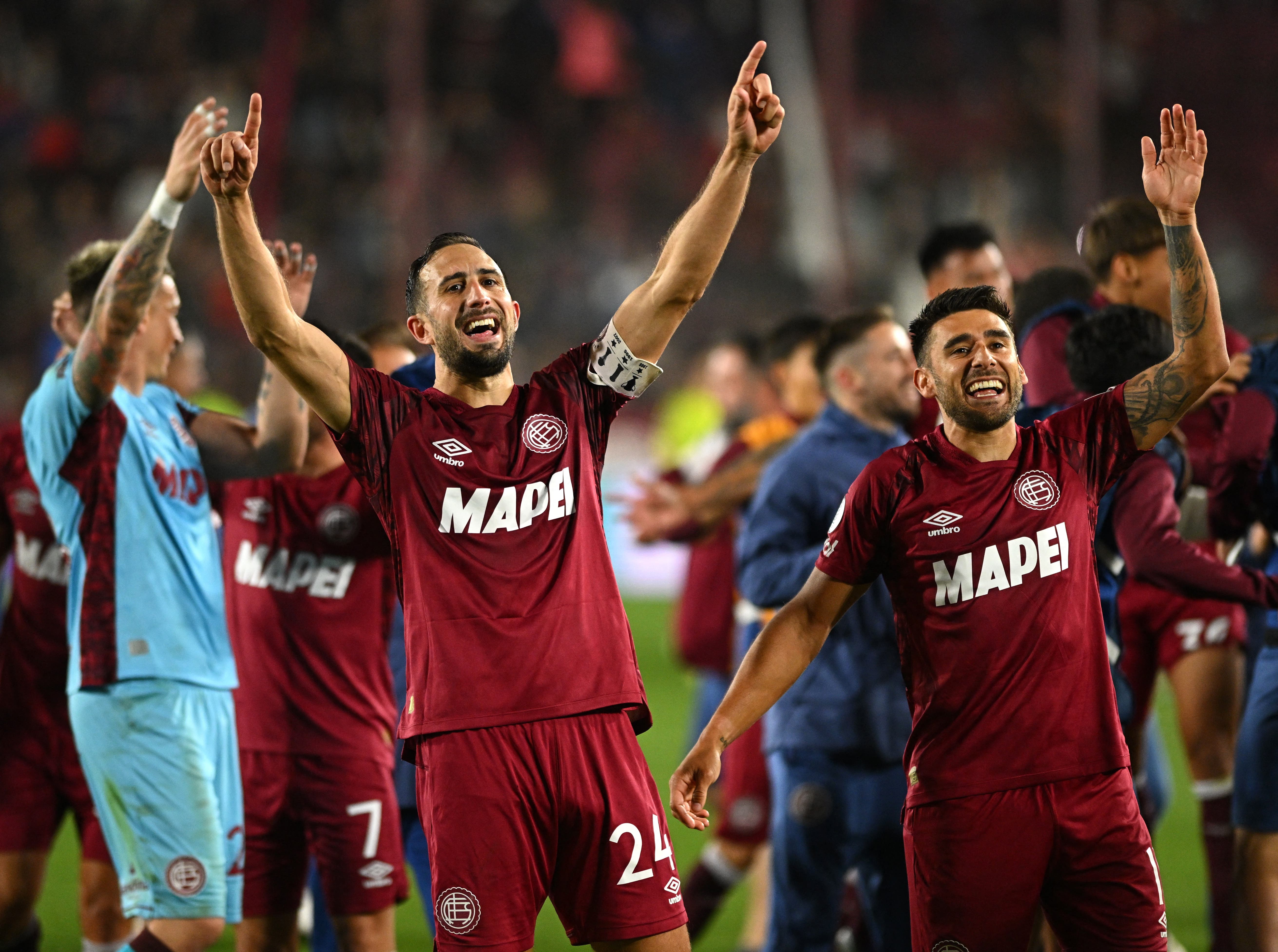 Soccer Football - Copa Sudamericana - Semi Final - Second Leg - Lanus v Universidad de Chile - Estadio Ciudad de Lanus - Nestor Diaz Perez, Lanus, Argentina - October 30, 2025 Lanus' Carlos Izquierdoz celebrates with Eduardo Salvio after the match REUTERS/Rodrigo Valle