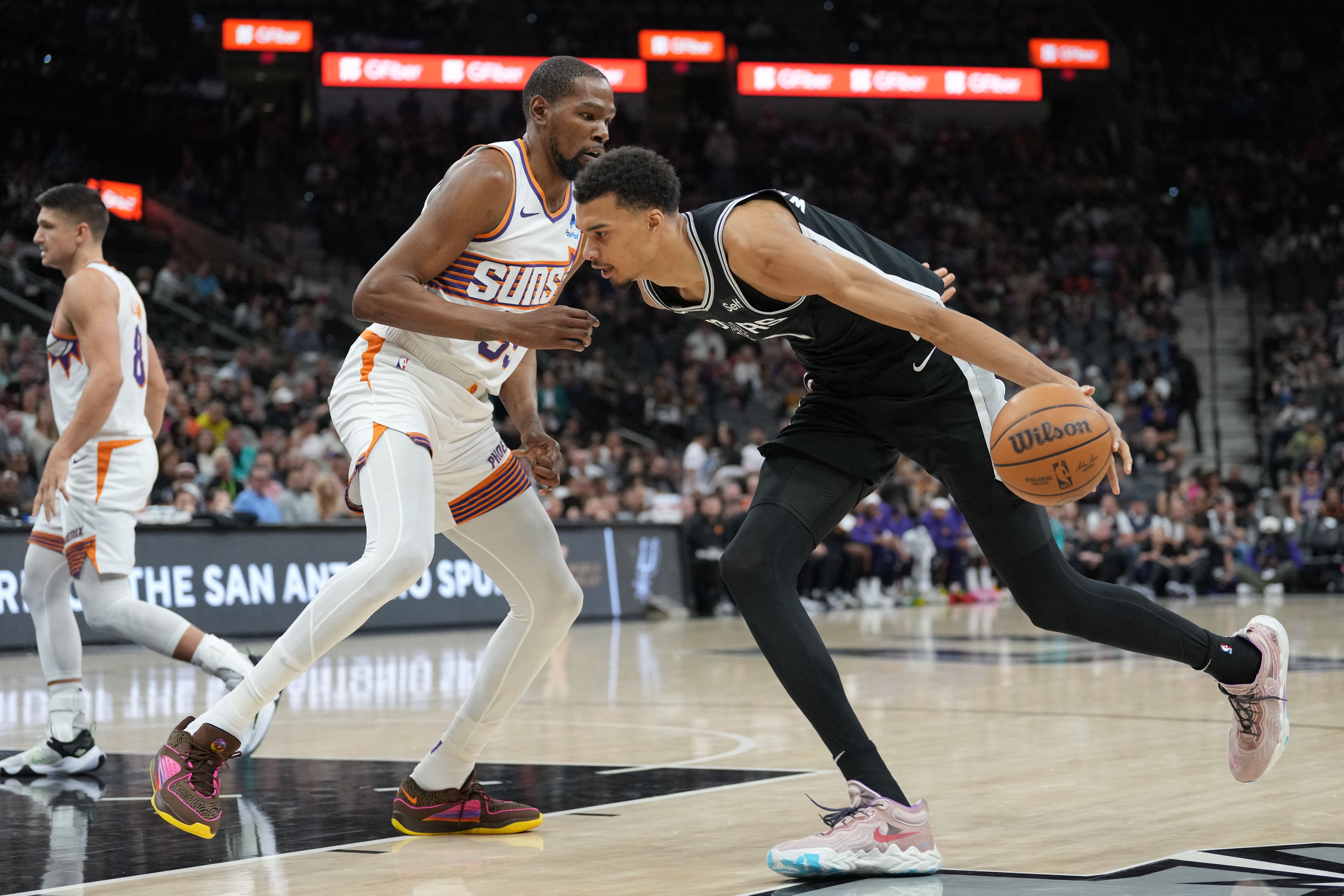 San Antonio Spurs center Victor Wembanyama (1) dribbles against Phoenix Suns forward Kevin Durant (35)