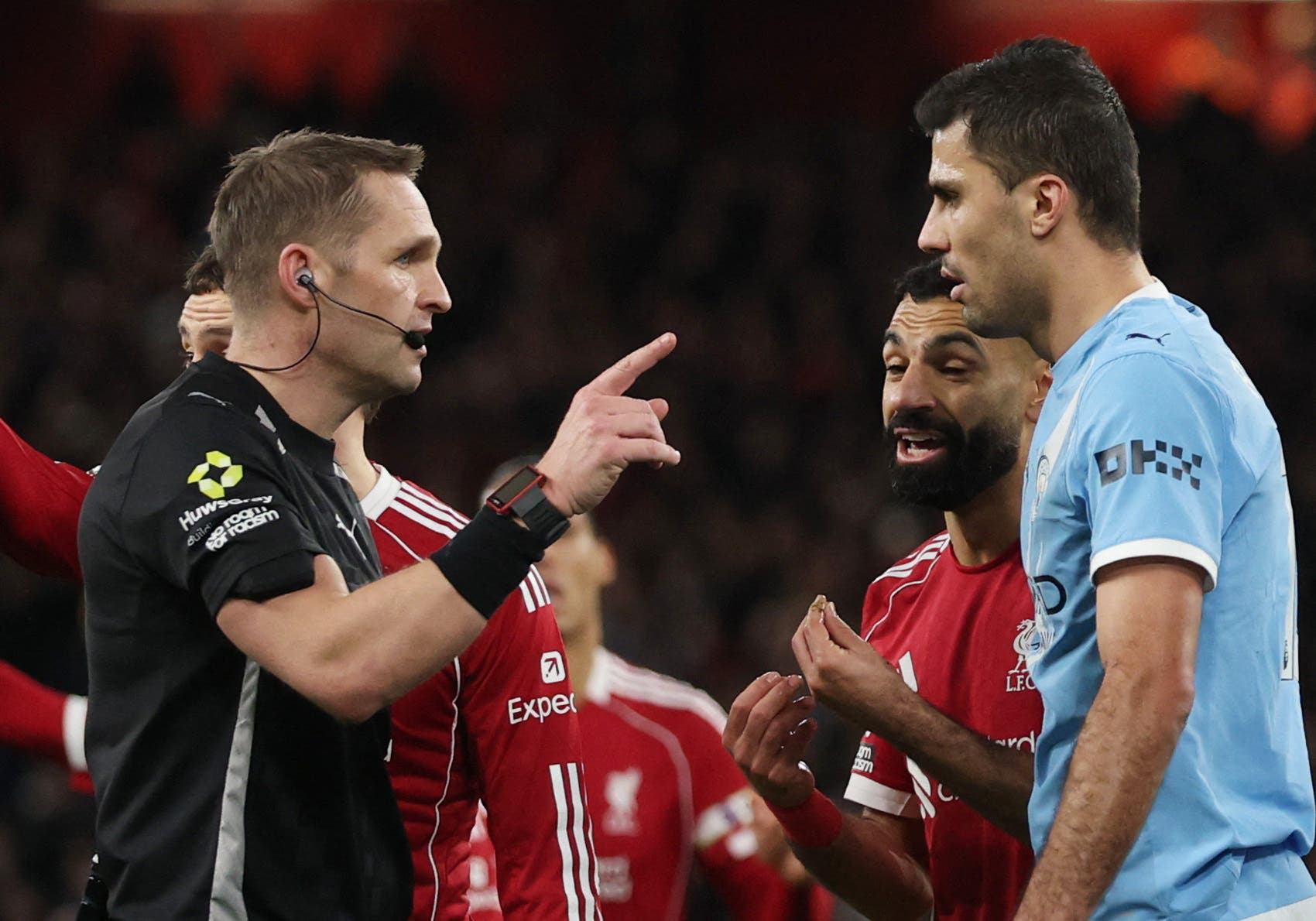 Soccer Football - Premier League - Liverpool v Manchester City - Anfield, Liverpool, Britain - February 8, 2026 Referee Craig Pawson speaks with Manchester City's Rodri and Liverpool's Mohamed Salah REUTERS/Phil Noble