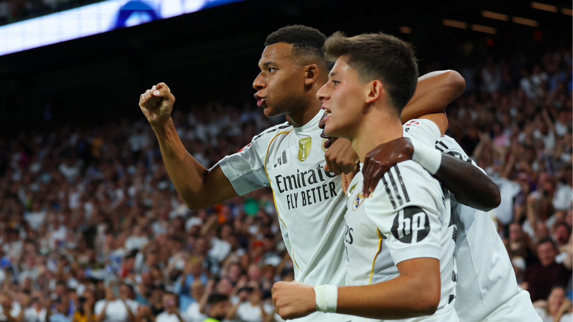 Kylian Mbappé celebrates a goal with Arda Güler and Vinícius Junior during a match with Real Madrid.