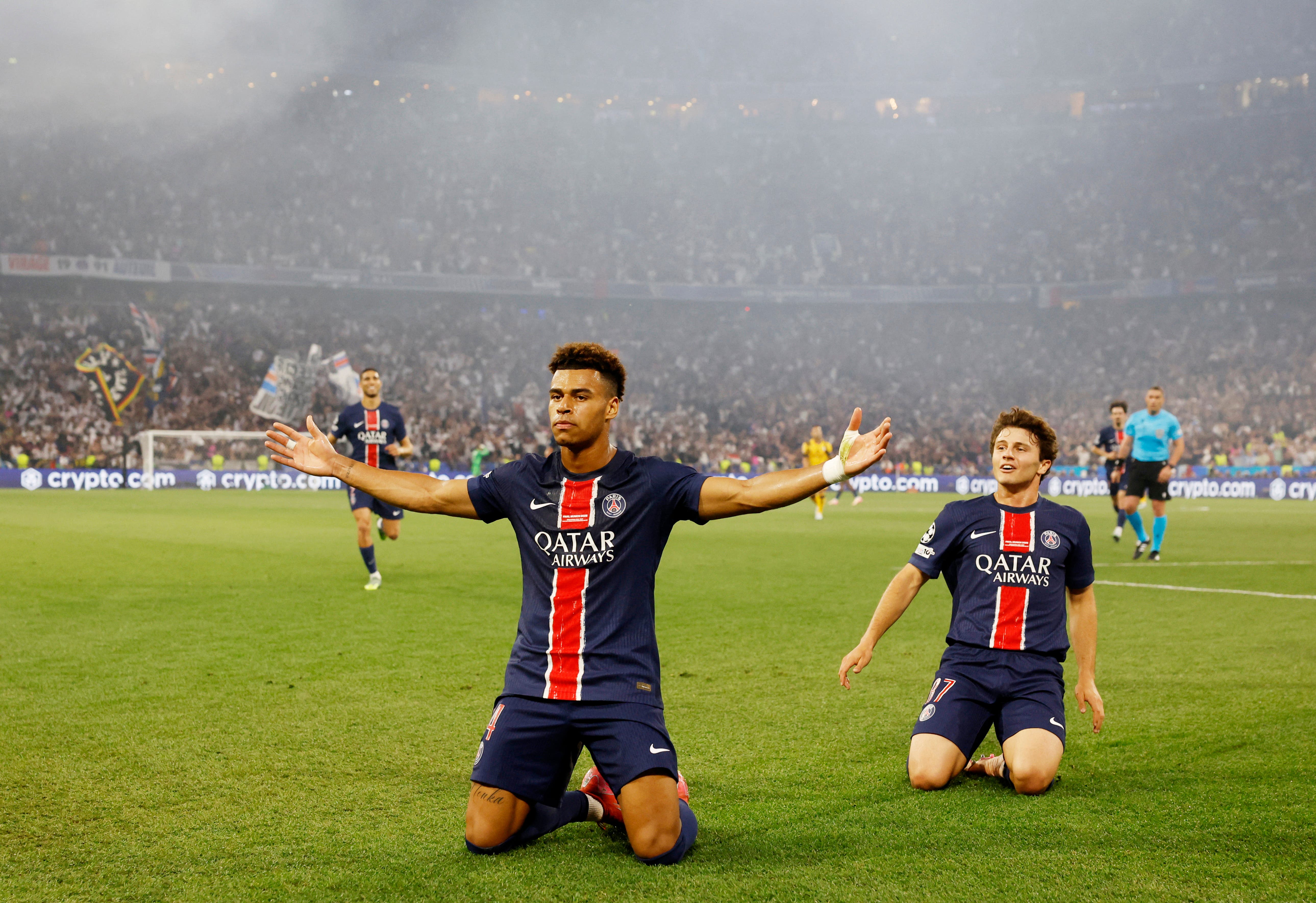 Paris St Germain's Desire Doue celebrates scoring their second goal with Joao Neves