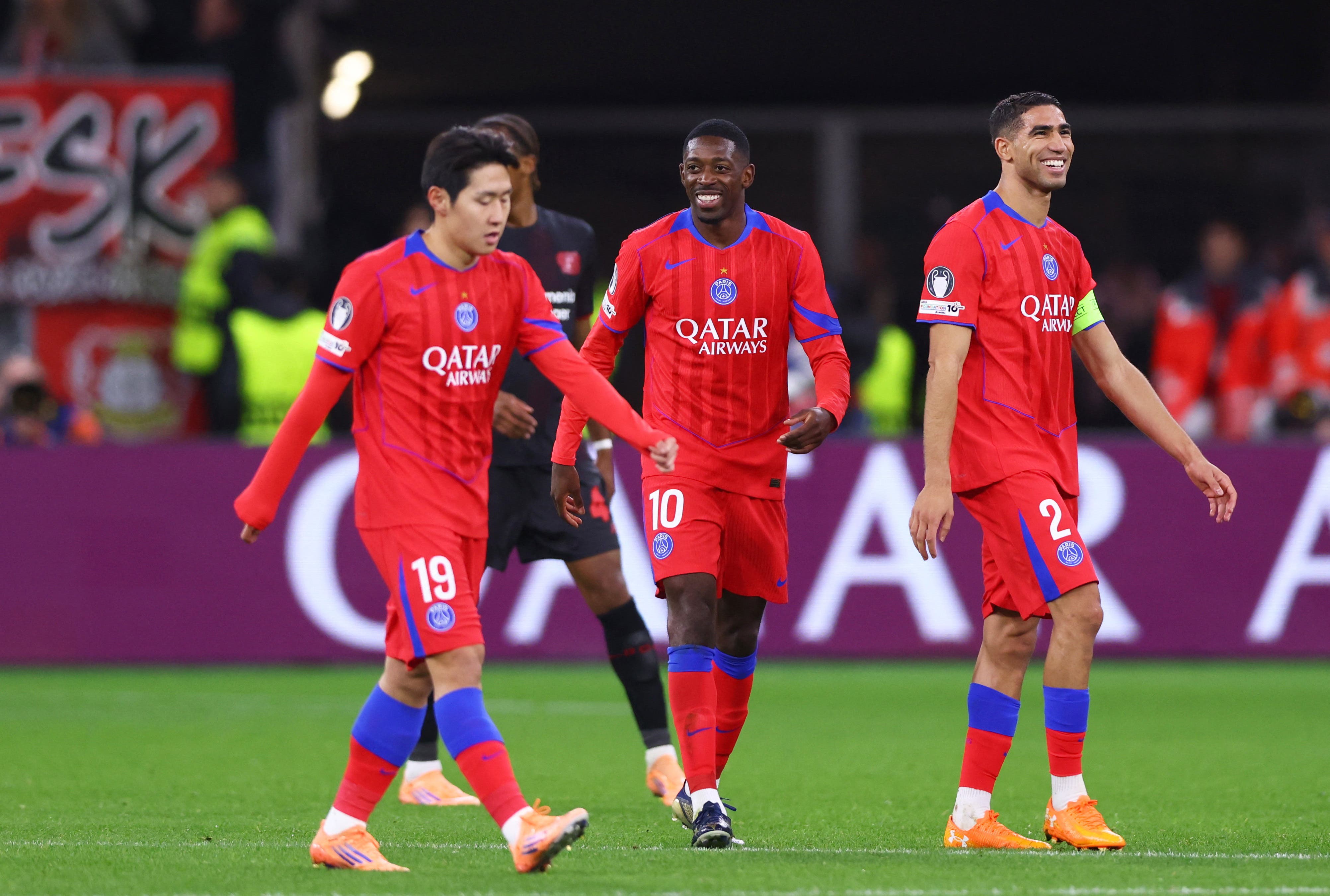 Soccer Football - UEFA Champions League - Bayer Leverkusen v Paris St Germain - BayArena, Leverkusen, Germany - October 21, 2025 Paris St Germain's Ousmane Dembele celebrates scoring their sixth goal with Lee Kang-in and Achraf Hakimi REUTERS/Thilo Schmuelgen