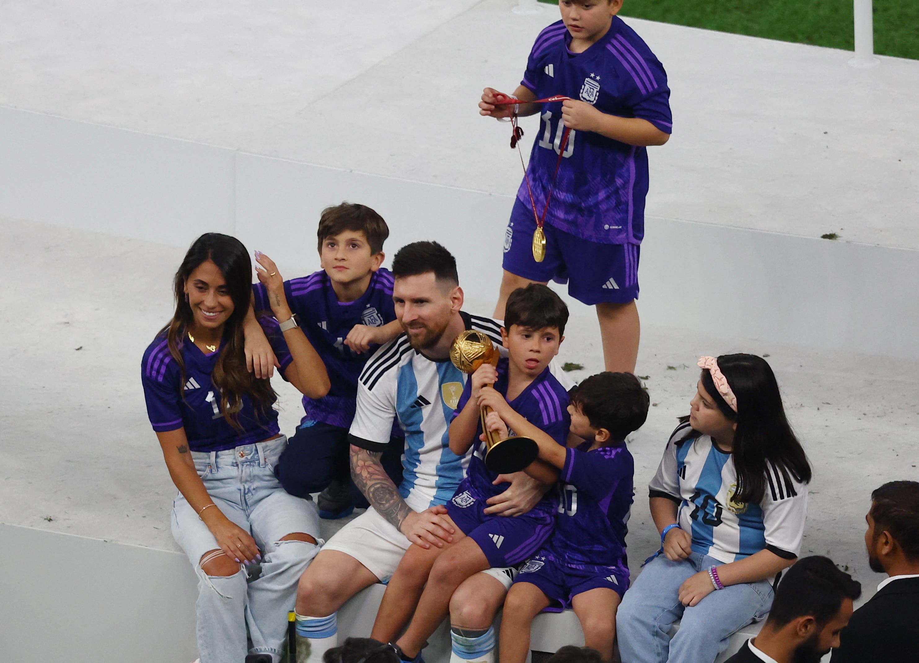 Argentina's Lionel Messi sits with his wife Antonela Roccuzzo and sons Ciro, Mateo and Thiago after winning the World Cup