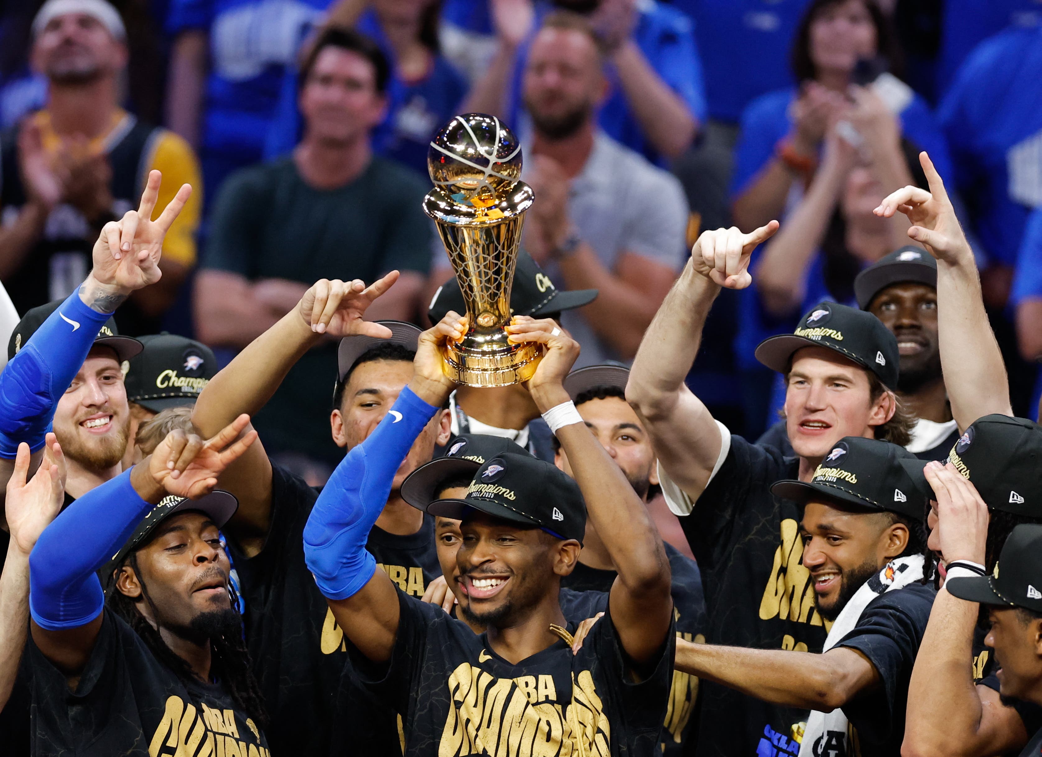 Oklahoma City Thunder lifting the NBA Finals trophy.