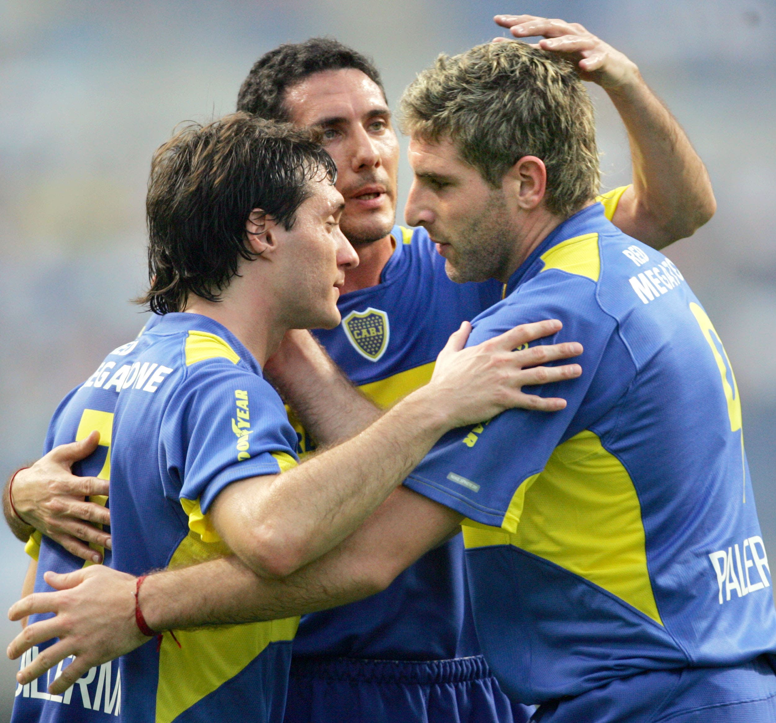 Argentine club Boca Juniors' Martin Palermo (R) celebrates with teammates Guillermo Barros Schelotto (L) and captain Diego Cagna after scoring