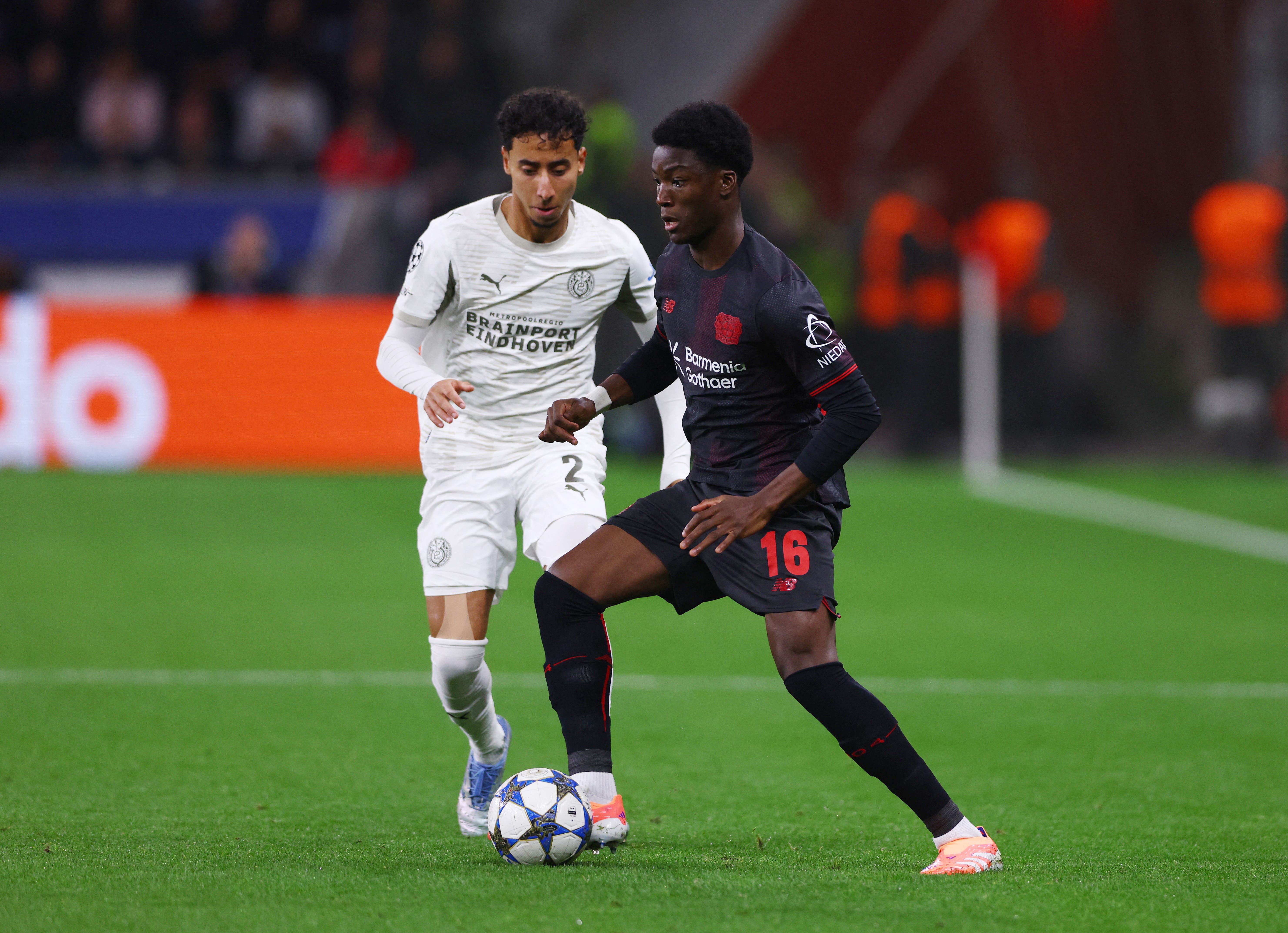 Soccer Football - UEFA Champions League - Bayer Leverkusen v PSV Eindhoven - BayArena, Leverkusen, Germany - October 1, 2025 Bayer Leverkusen's Axel Tape in action with PSV Eindhoven's Anass Salah-Eddine REUTERS/Thilo Schmuelgen