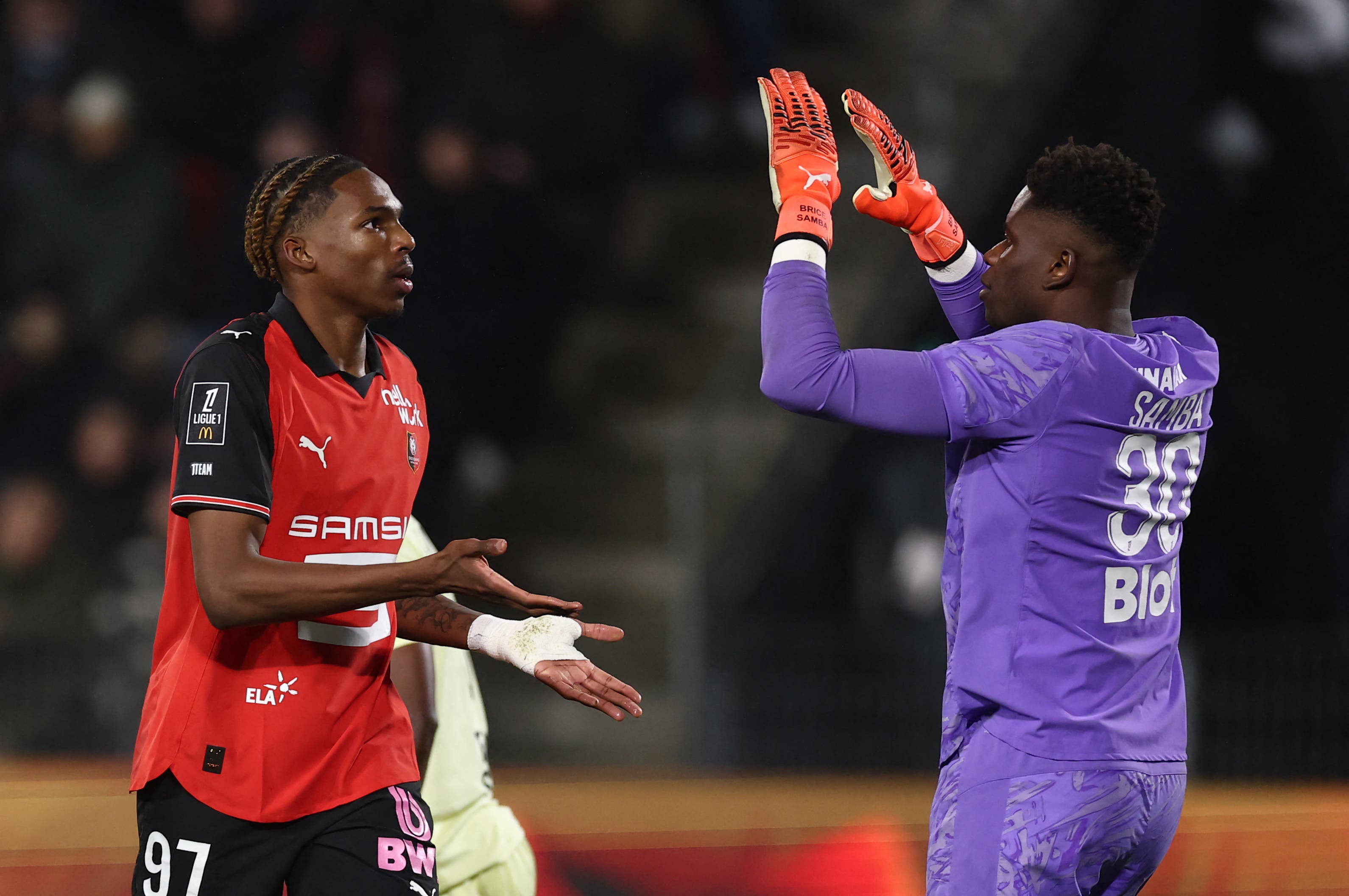Soccer Football - Ligue 1 - Stade Rennes v AS Monaco - Roazhon Park, Rennes, France - November 22, 2025 Stade Rennes' Jeremy Jacquet reacts with Brice Samba REUTERS/Stephane Mahe
