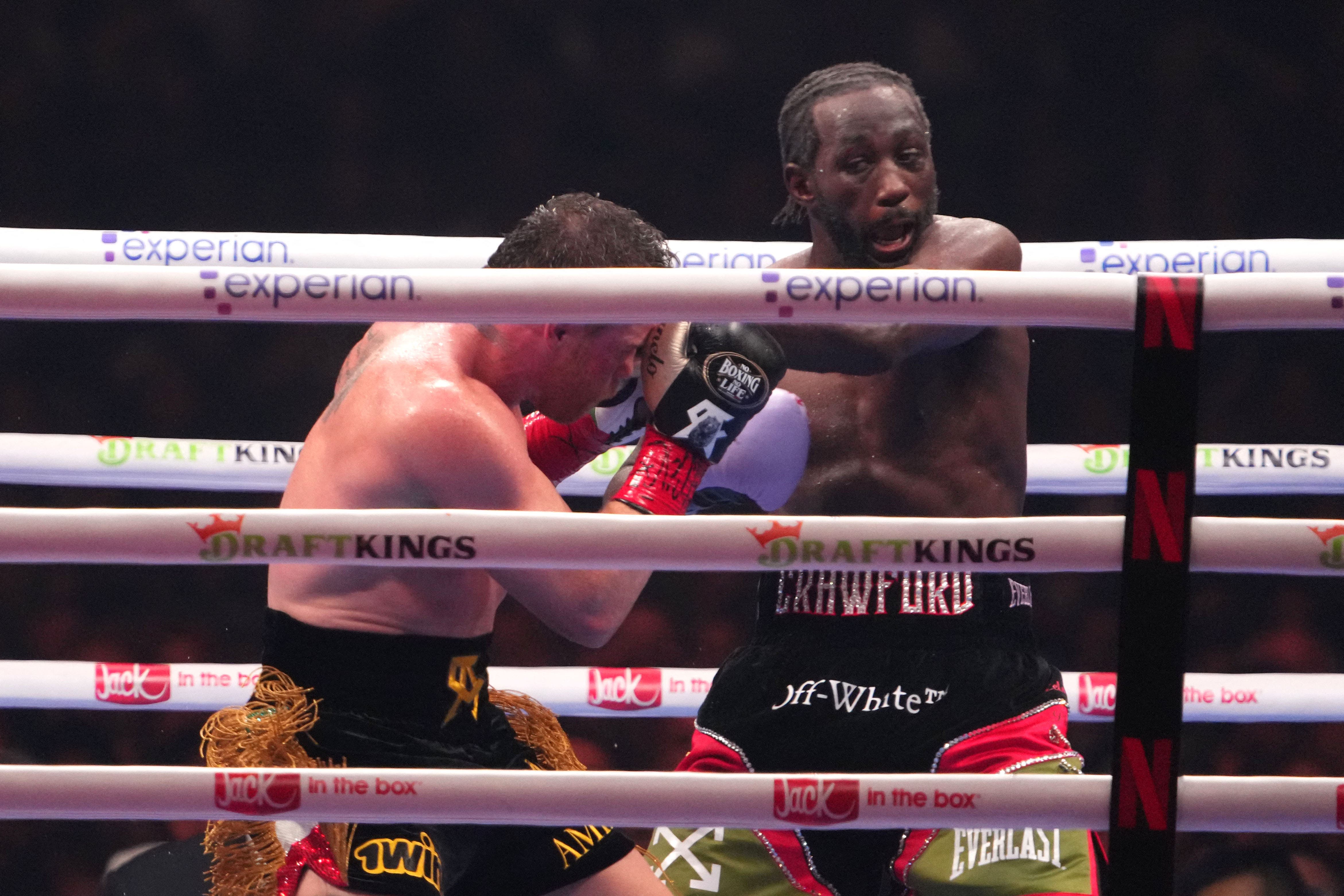 Sep 13, 2025; Las Vegas, Nevada, USA; Canelo Alvarez (black/gold trunks) and Terence Crawford (black/red trunks) box during their super middleweight title bout at Allegiant Stadium. Mandatory Credit: Joe Camporeale-Imagn Images