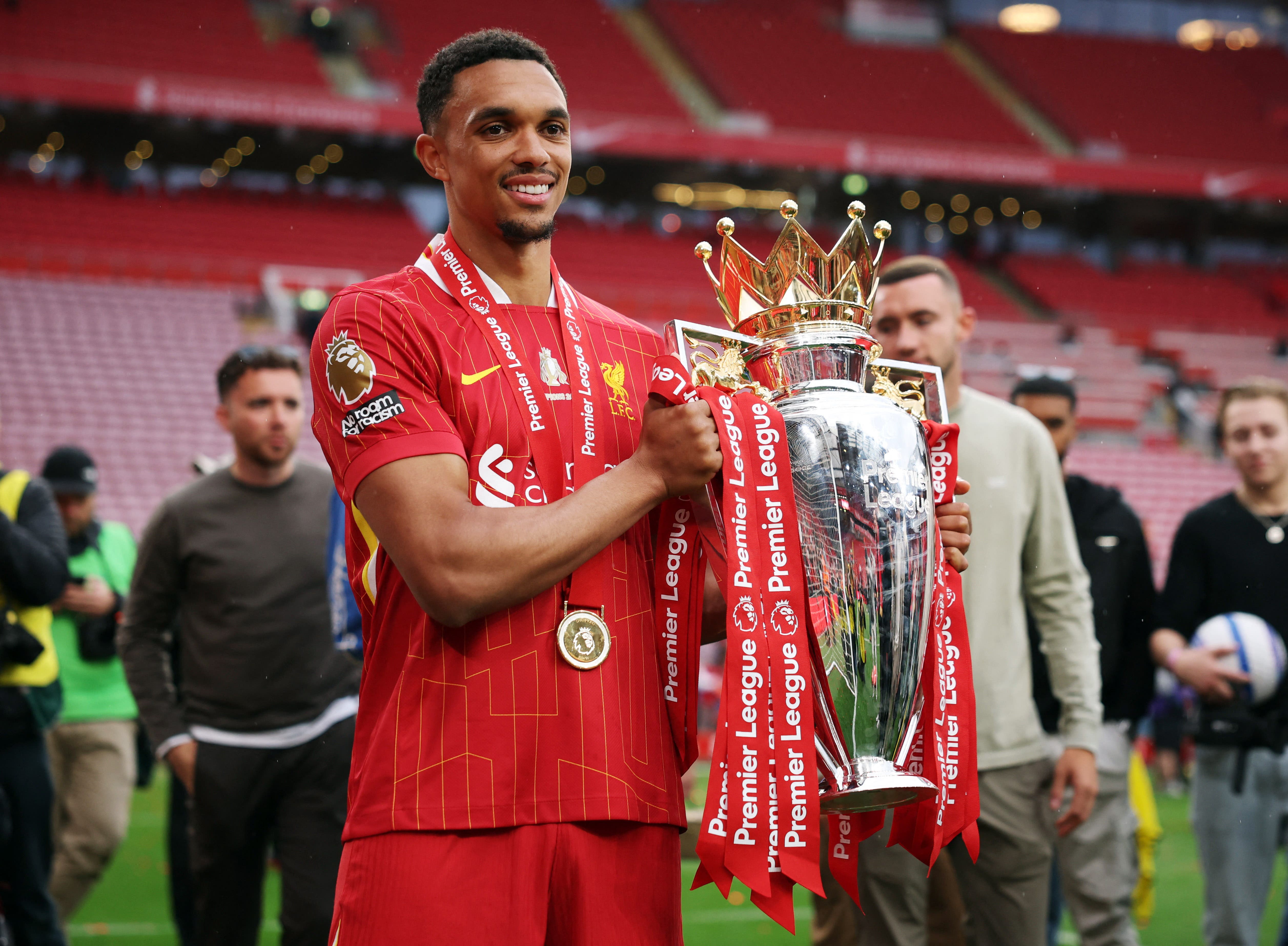 Liverpool's Trent Alexander-Arnold celebrates with the trophy after winning the Premier League