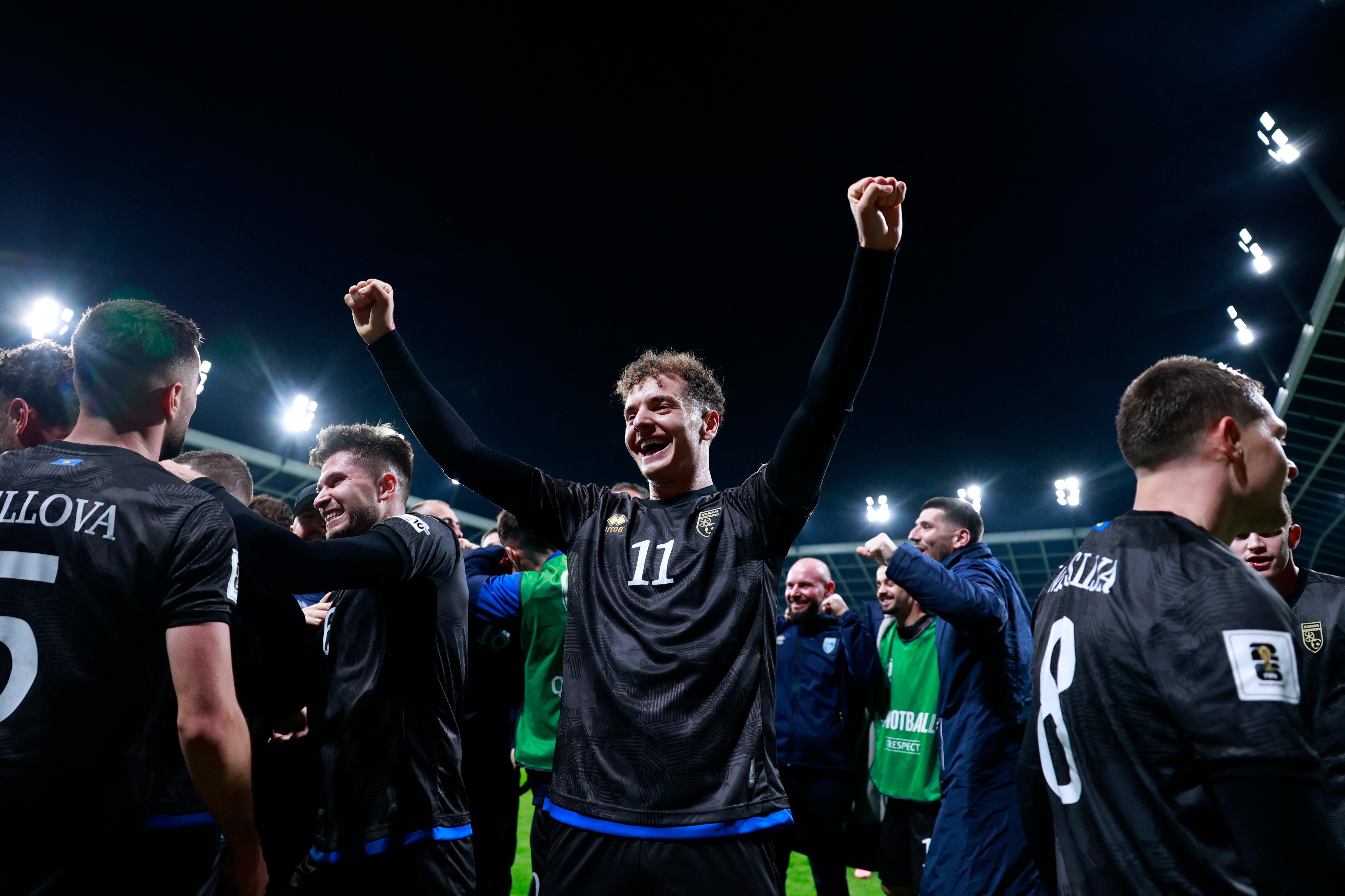 Soccer Football - FIFA World Cup - UEFA Qualifiers - Group B - Slovenia v Kosovo - Stadion Stozice, Ljubljana, Slovenia - November 15, 2025 Kosovo's Fisnik Asllani celebrates their second goal with teammates, an own goal scored by Slovenia's Zan Karnicnik REUTERS/Borut Zivulovic