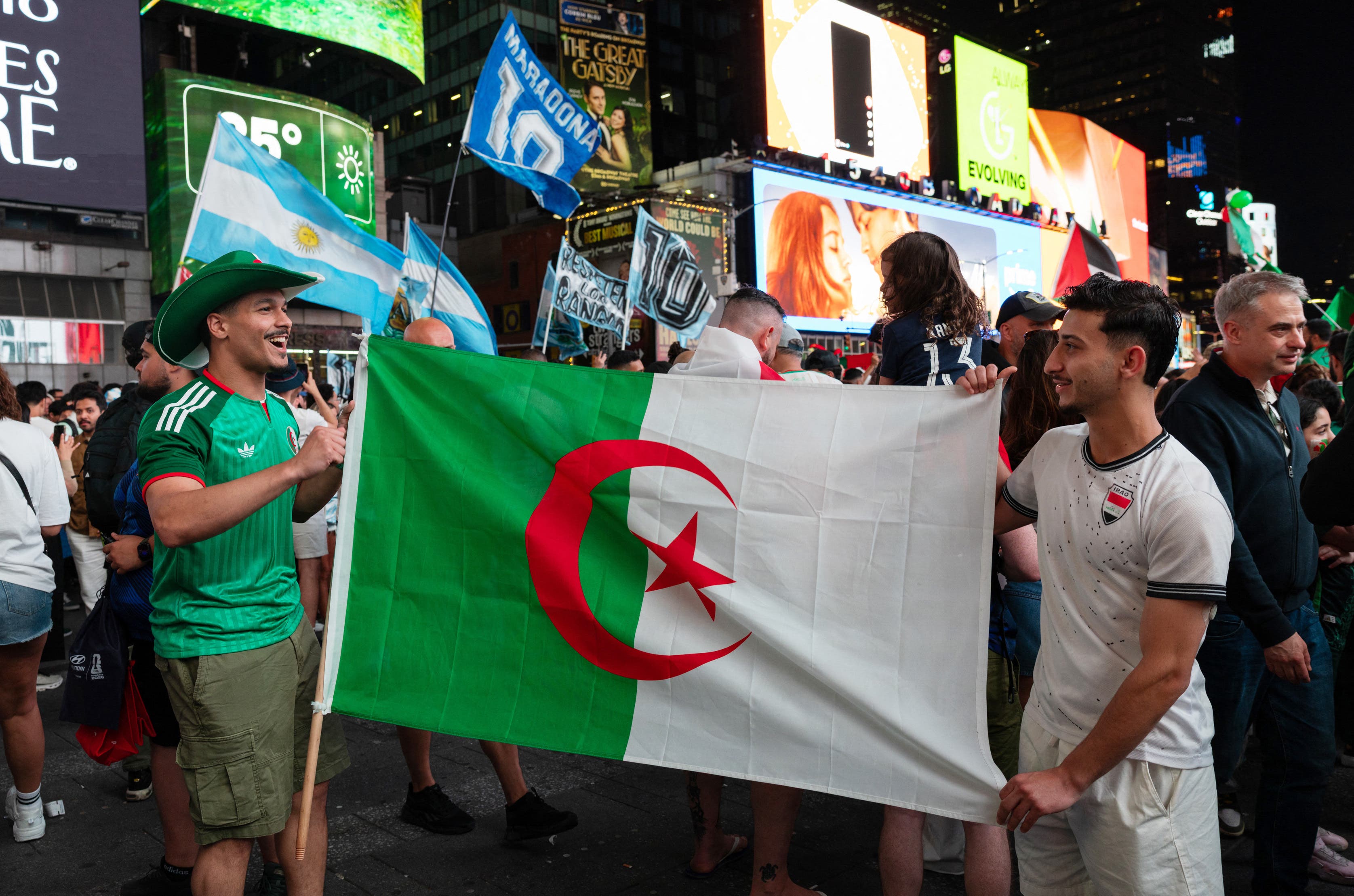 Soccer Football - FIFA World Cup 2026 - Argentina Fans gather in Times Square, New York - New York, New York, U.S. - June 15, 2026 Algeria fans display their national flag as they gather in Times Square REUTERS/Carolina Herrera
