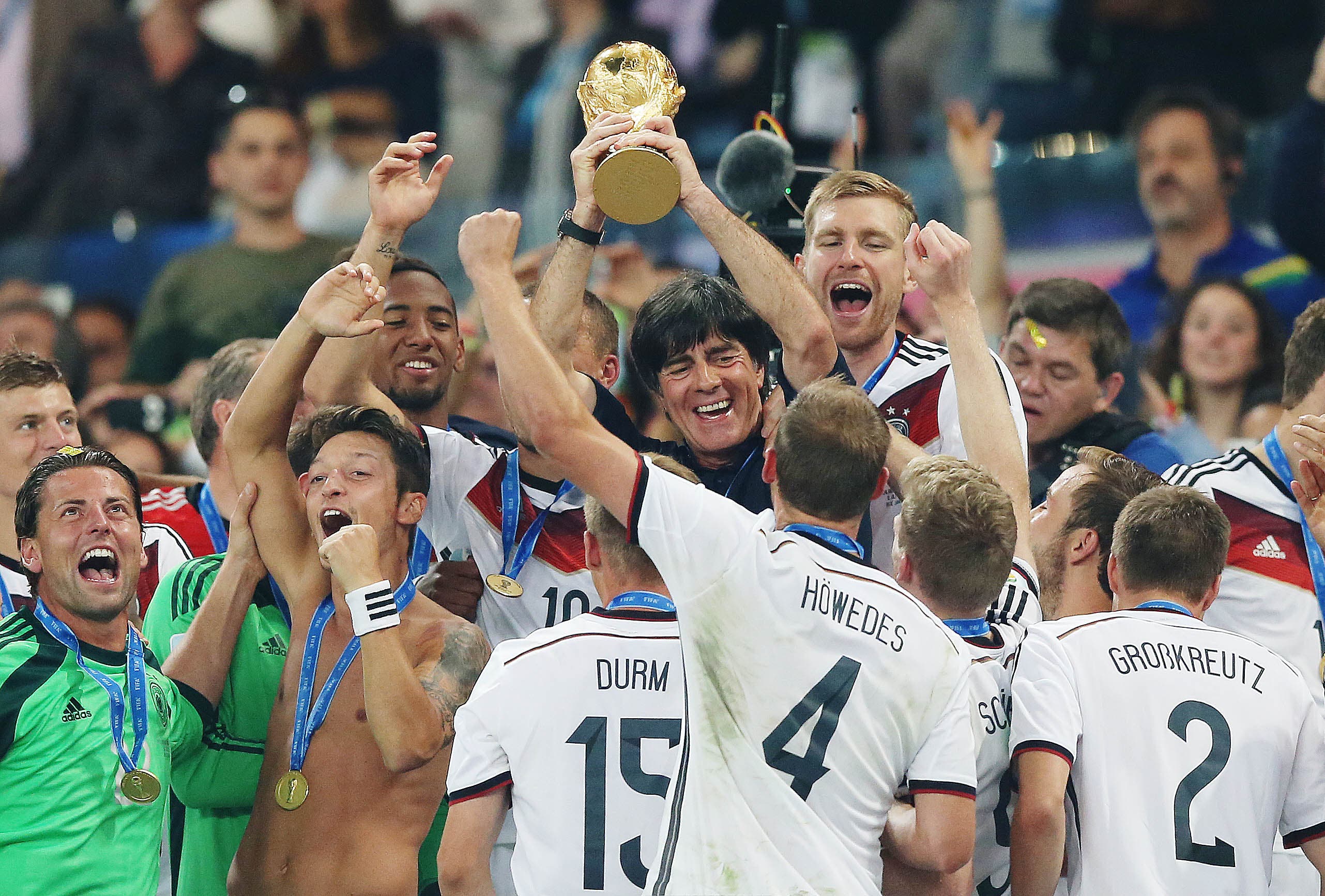 Football - Germany v Argentina - FIFA World Cup Brazil 2014 - Final - Estadio do Maracana, Rio de Janeiro, Brazil - 13/7/14 Germany coach Joachim Low lifts the FIFA World Cup trophy as they celebrate after victory Mandatory Credit: Action Images / Lee Smith Livepic EDITORIAL USE ONLY.