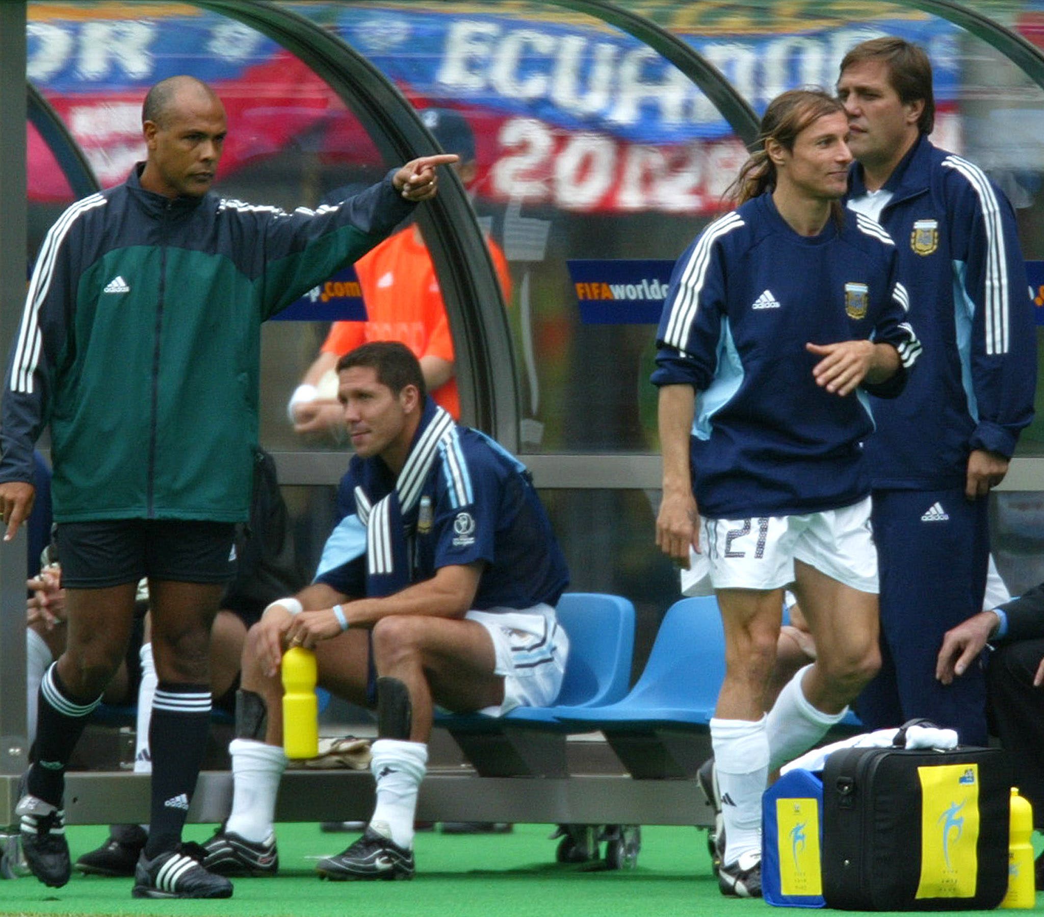 Argentina's substitute Claudio Caniggia (front-R) is directed to leave the bench by an unidentified FIFA official (L) after being given a red card by referee Ali Bujsaim of the United Arab Emirates during their group F match against Sweden at the World Cup finals in Sendai June 12, 2002. REUTERS/Dylan Martinez CP/JP