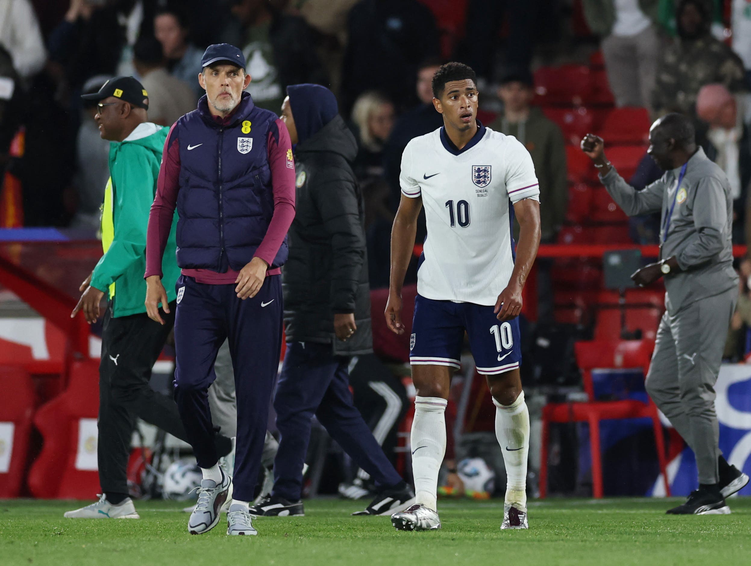 Thomas Tuchel walks along Jude Bellingham during an England's National Team match.