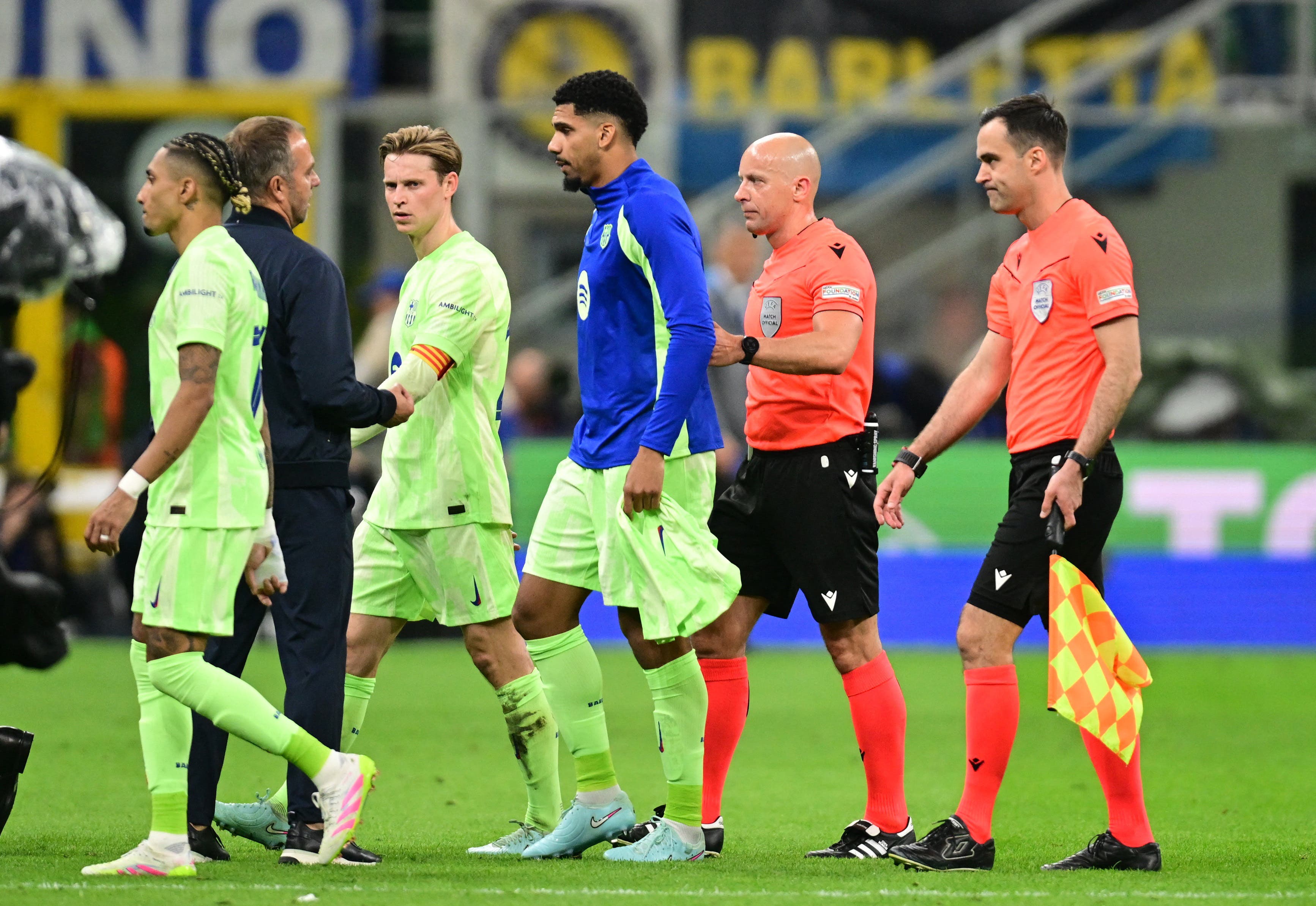 Barcelona coach Hansi Flick remonstrates with referee Szymon Marciniak 