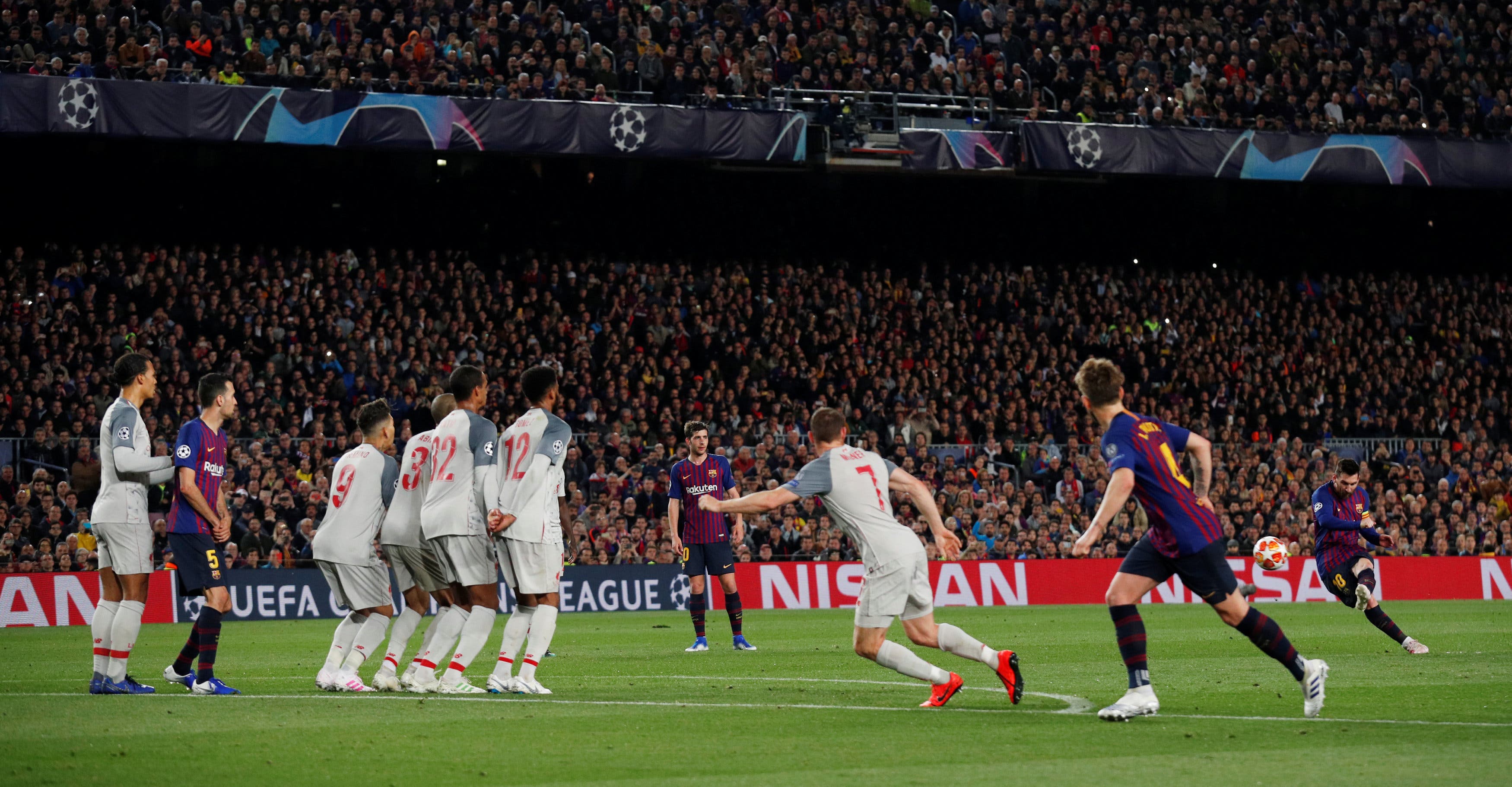 Barcelona's Lionel Messi scores their third goal from a free kick