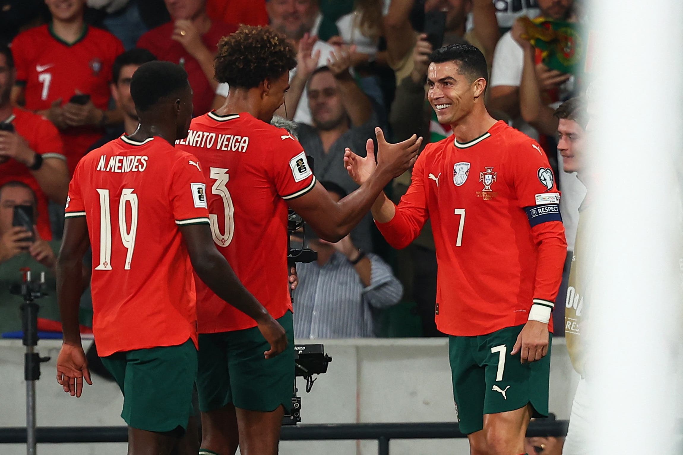 Soccer Football - FIFA World Cup - UEFA Qualifiers - Group F - Portugal v Hungary - Estadio Jose Alvalade, Lisbon, Portugal - October 14, 2025 Portugal's Cristiano Ronaldo celebrates scoring their second goal with Renato Veiga REUTERS/Pedro Nunes