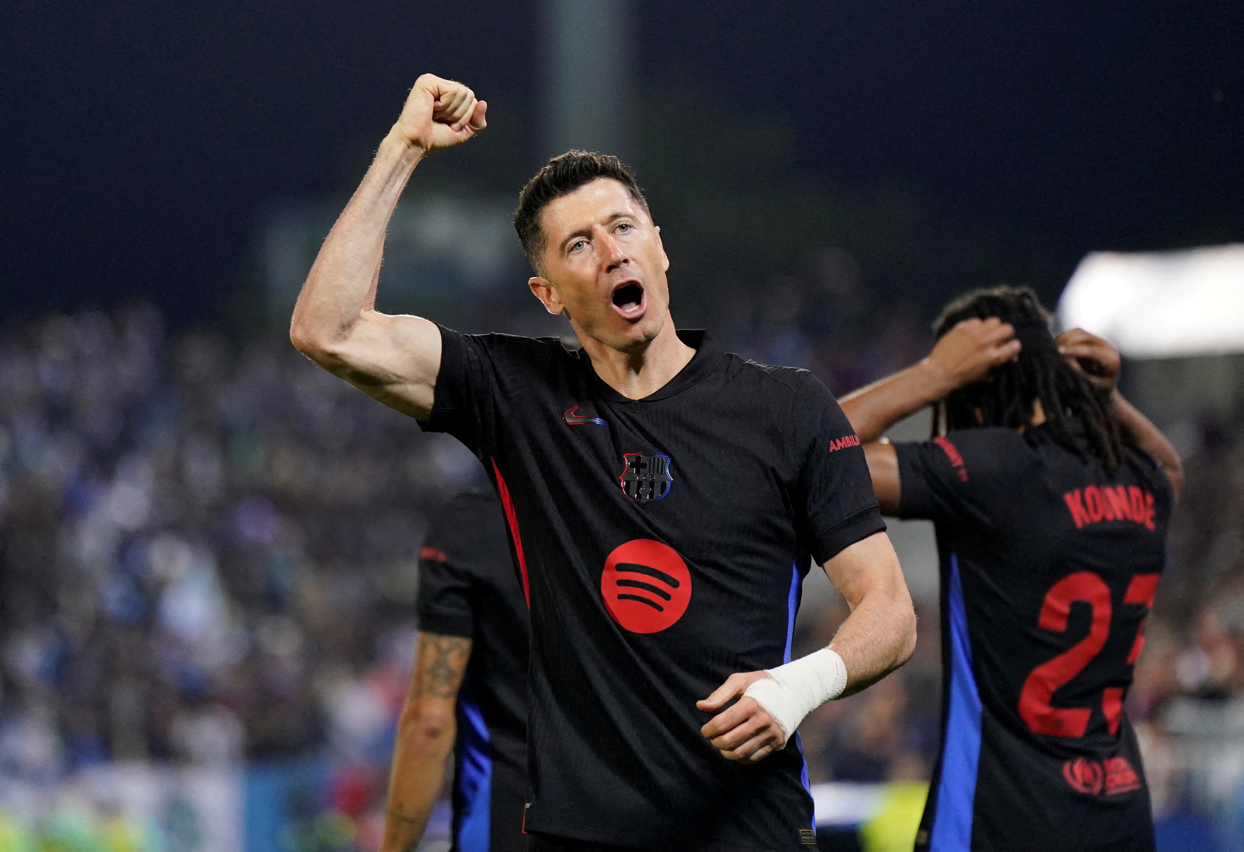 FC Barcelona's Robert Lewandowski celebrates after Leganes' Jorge Saenz scored an own goal for their first goal 