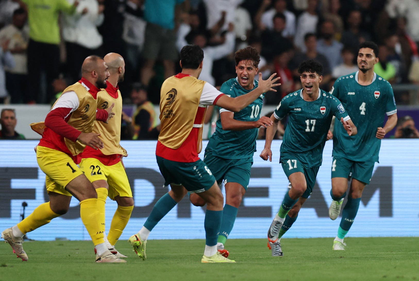 Soccer Football - FIFA World Cup - AFC Qualifiers - Play Off - Second Leg - Iraq v United Arab Emirates - Basra International Stadium, Basra, Iraq - November 18, 2025 Iraq's Mohannad Ali celebrates scoring their first goal with teammates REUTERS/Thaier Al-Sudani
