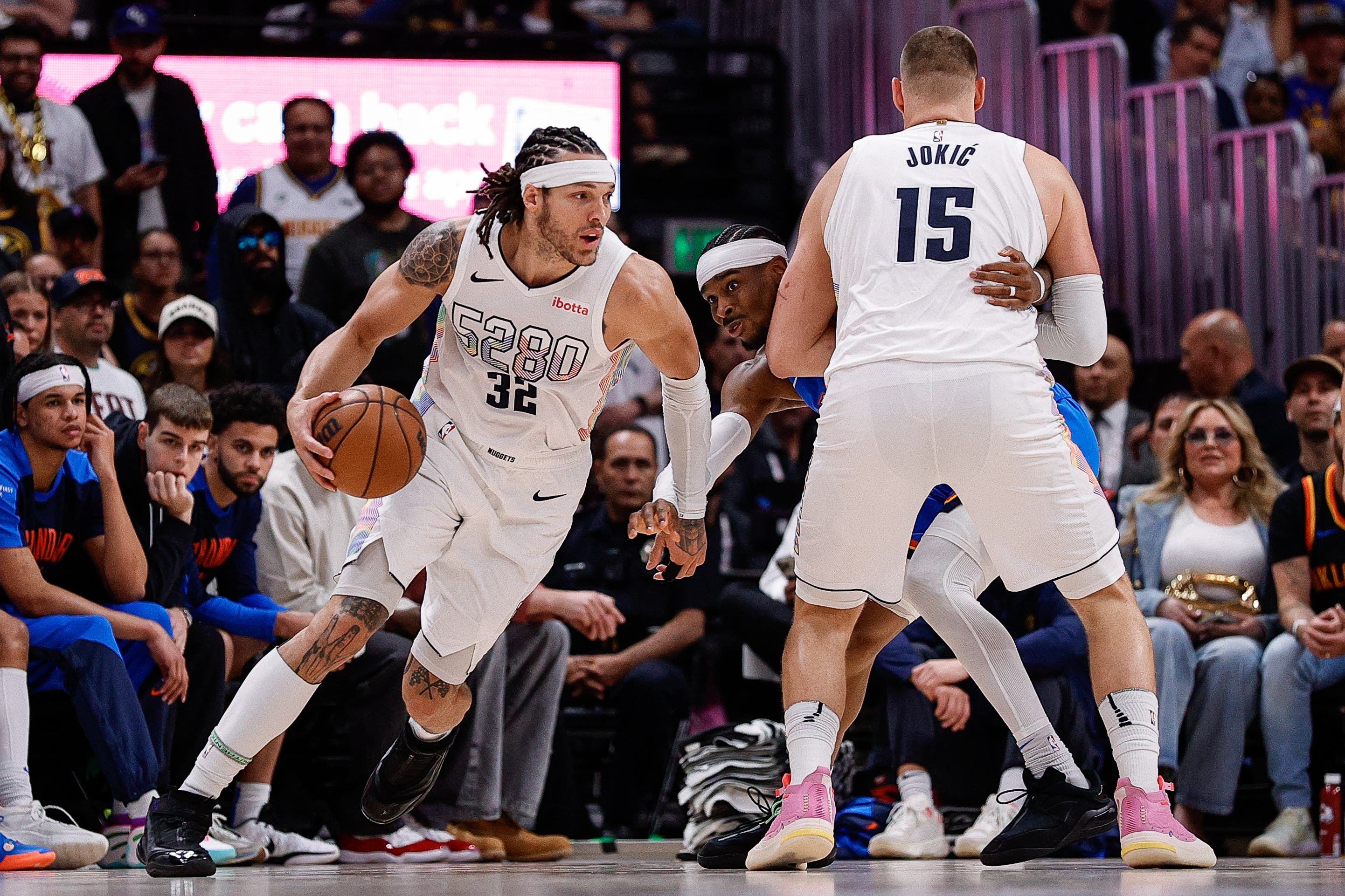Denver Nuggets' Aaron Gordon and Nikola Jokic playing against the Oklahoma City Thunder.