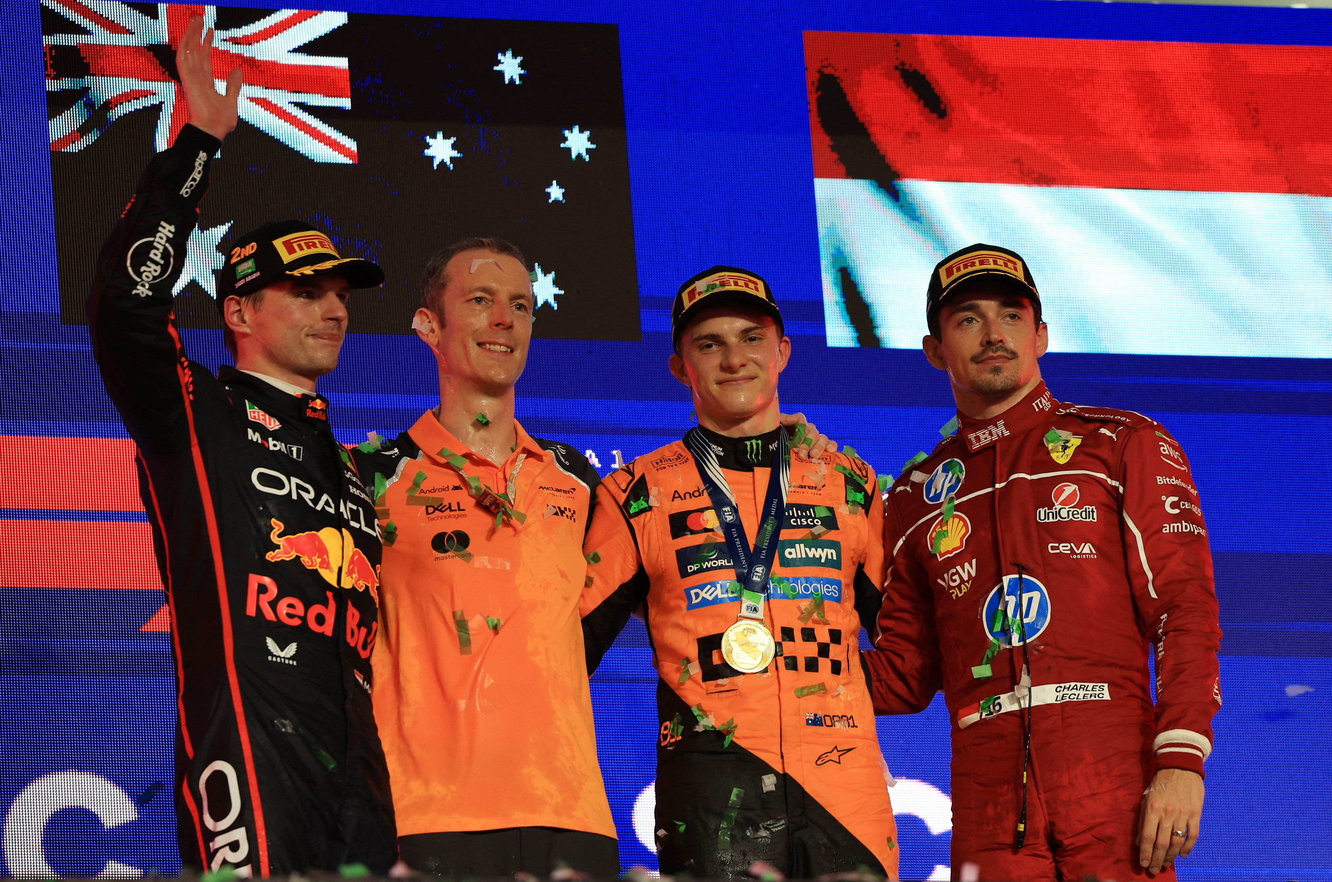 McLaren's Oscar Piastri poses for a picture on the podium after winning the Saudi Arabian Grand Prix alongside second placed Red Bull's Max Verstappen and third placed Ferrari's Charles Leclerc 