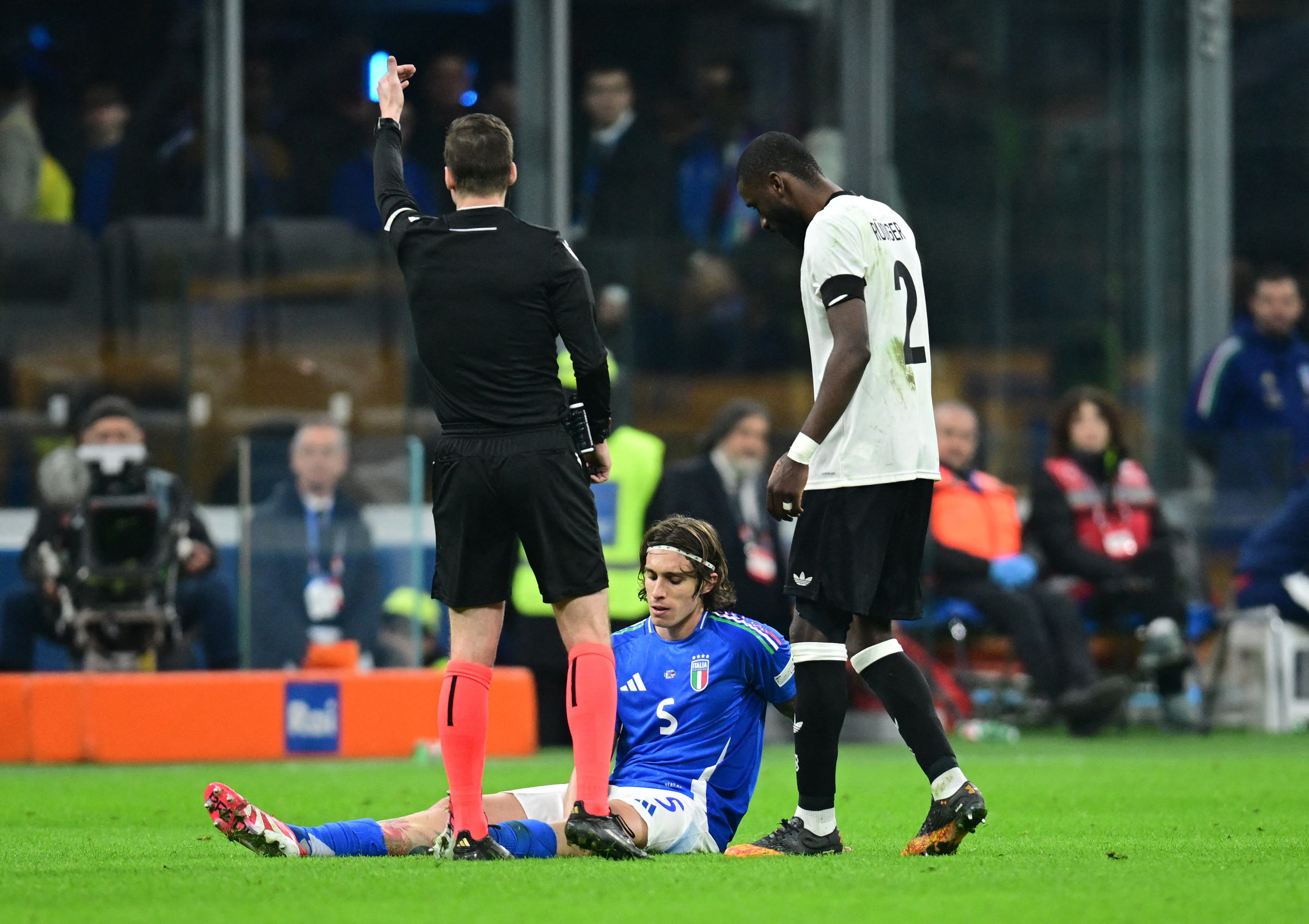 Italy's Riccardo Calafiori reacts after sustaining an injury 