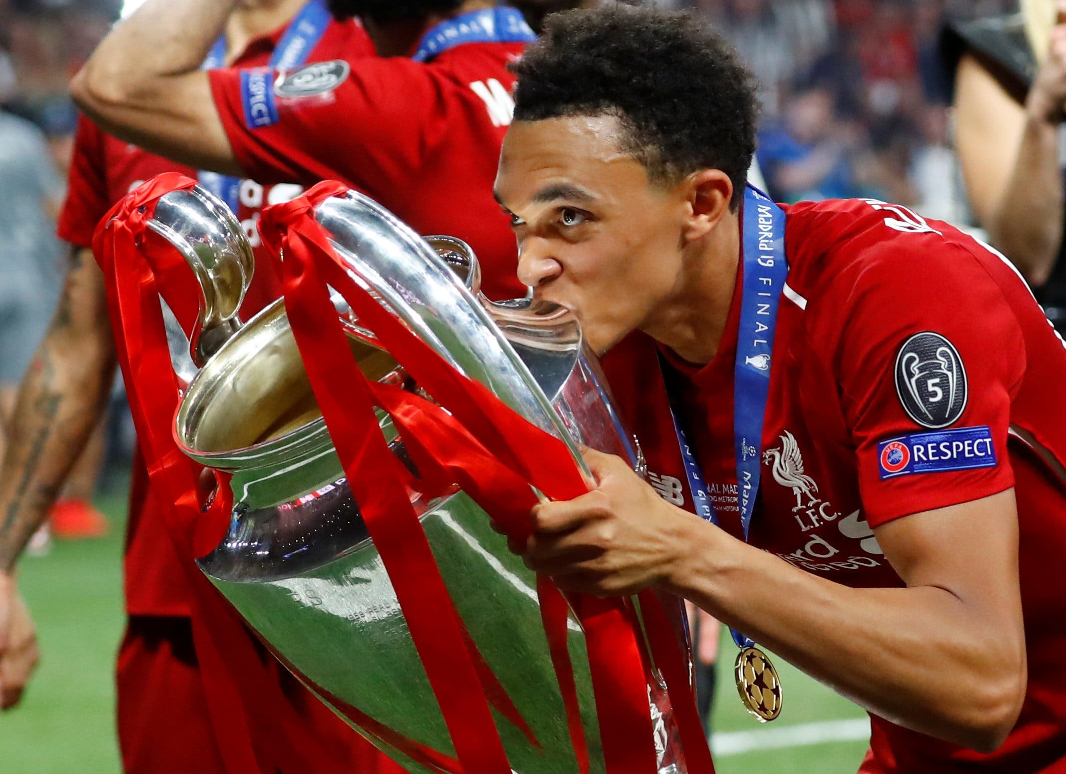 Liverpool's Trent Alexander-Arnold kisses the trophy as he celebrates after winning the Champions League