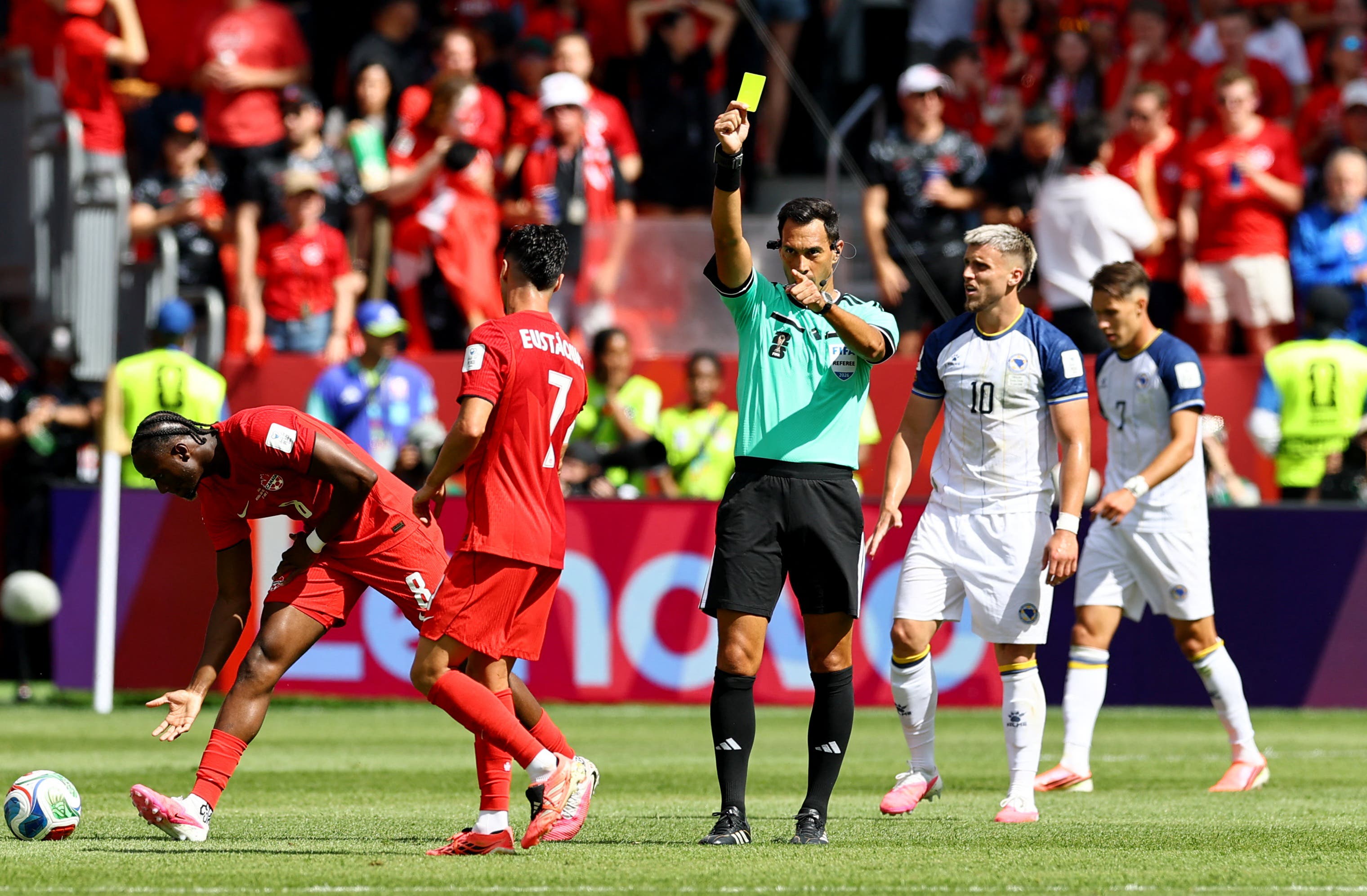 Soccer Football - FIFA World Cup 2026 - Group B - Canada v Bosnia and Herzegovina - Toronto Stadium, Toronto, Canada - June 12, 2026 Referee Facundo Tello shows a yellow card to Canada's Luc de Fougerolles REUTERS/Bernadett Szabo

