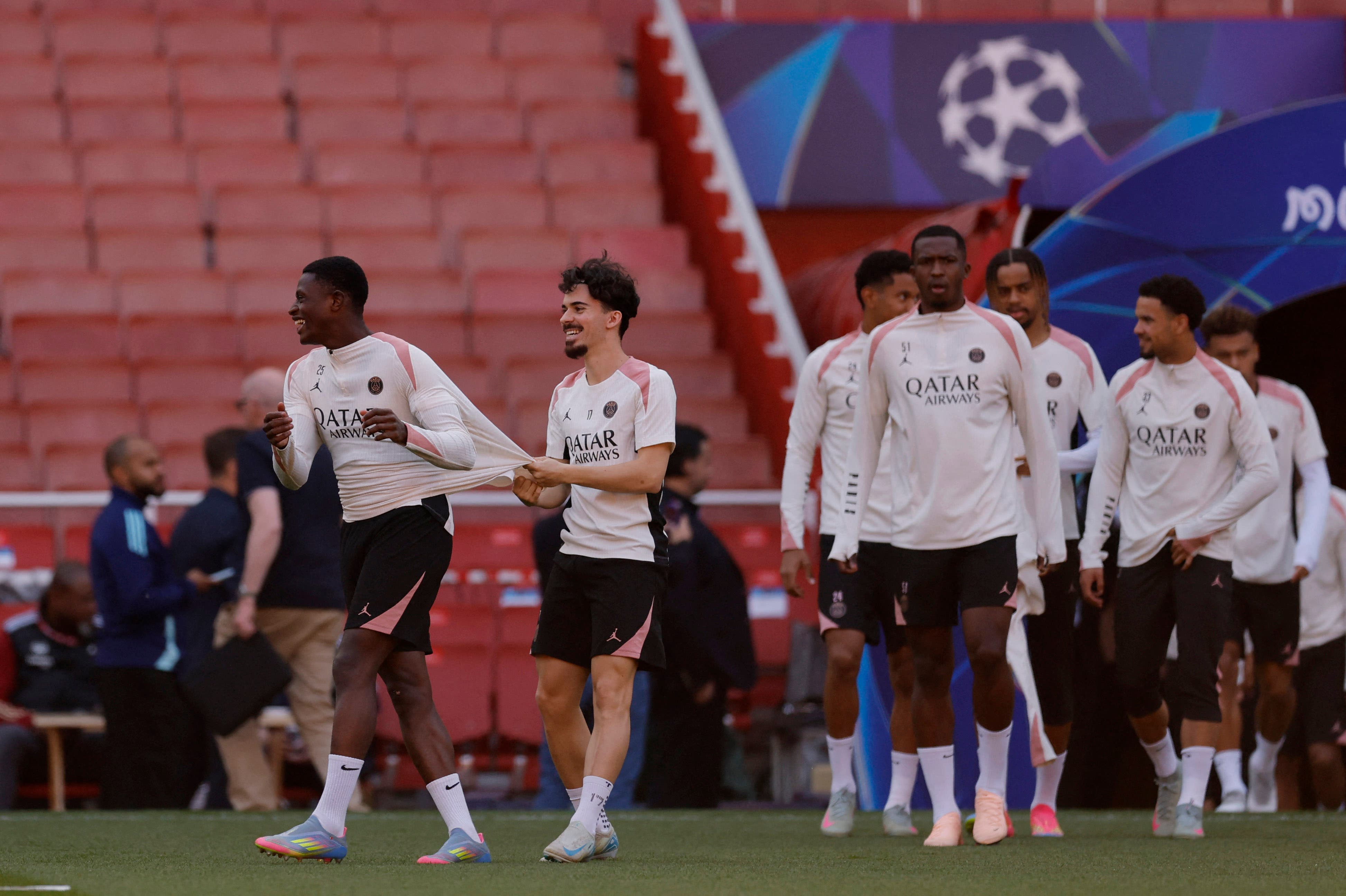 Paris St Germain's Vitinha with Nuno Mendes during training