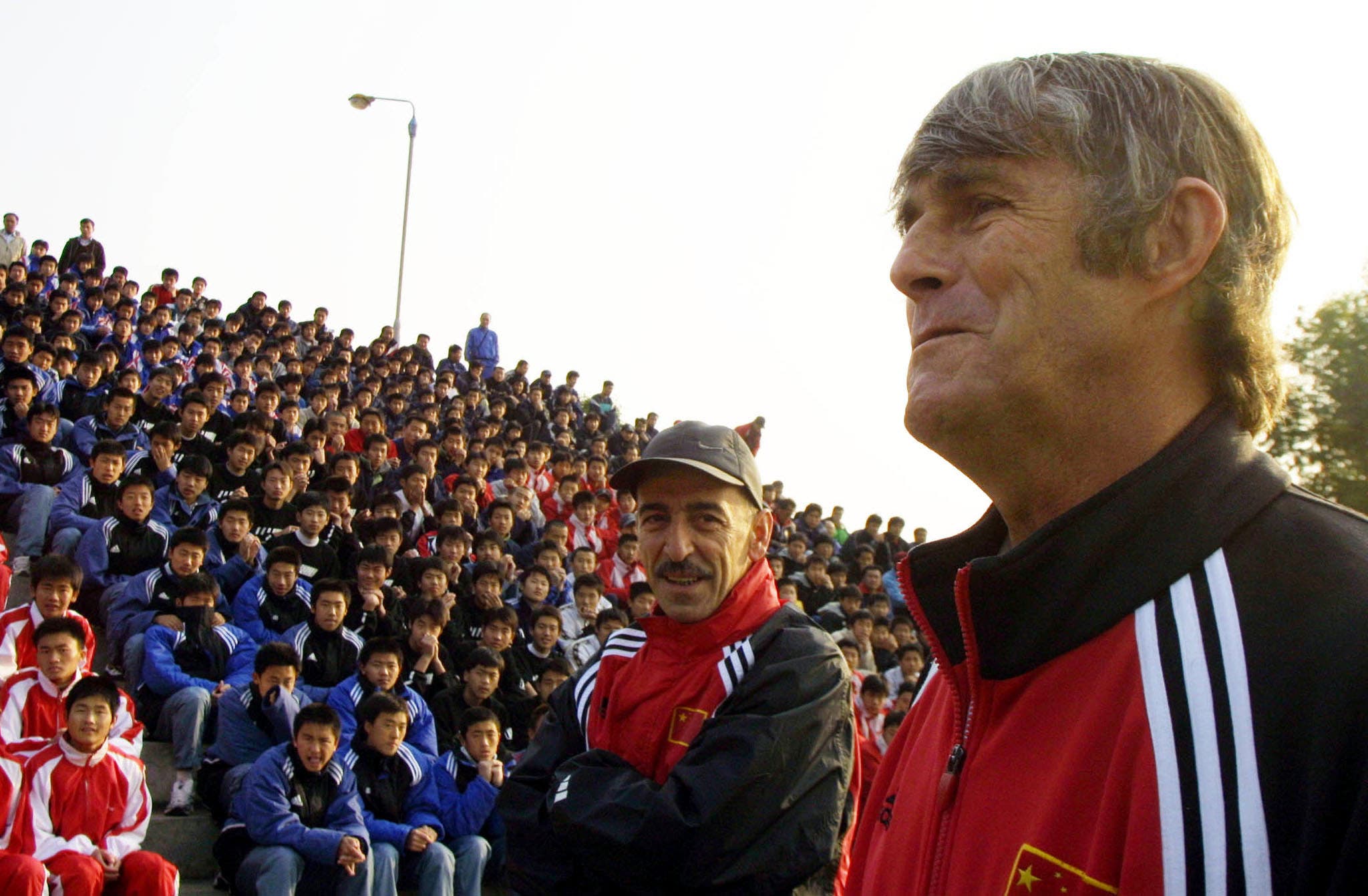 Chinese national soccer team coach Bora Milutinovic (R) conducts a training session for under 17-year-old Chinese soccer players in Guangzhou, Guangdong province, January 8, 2002. Milutinovic is the first coach to have brought five different teams into the World Cup finals after China reached the finals of the 2002 World Cup. REUTERS/China Photo GN/CP