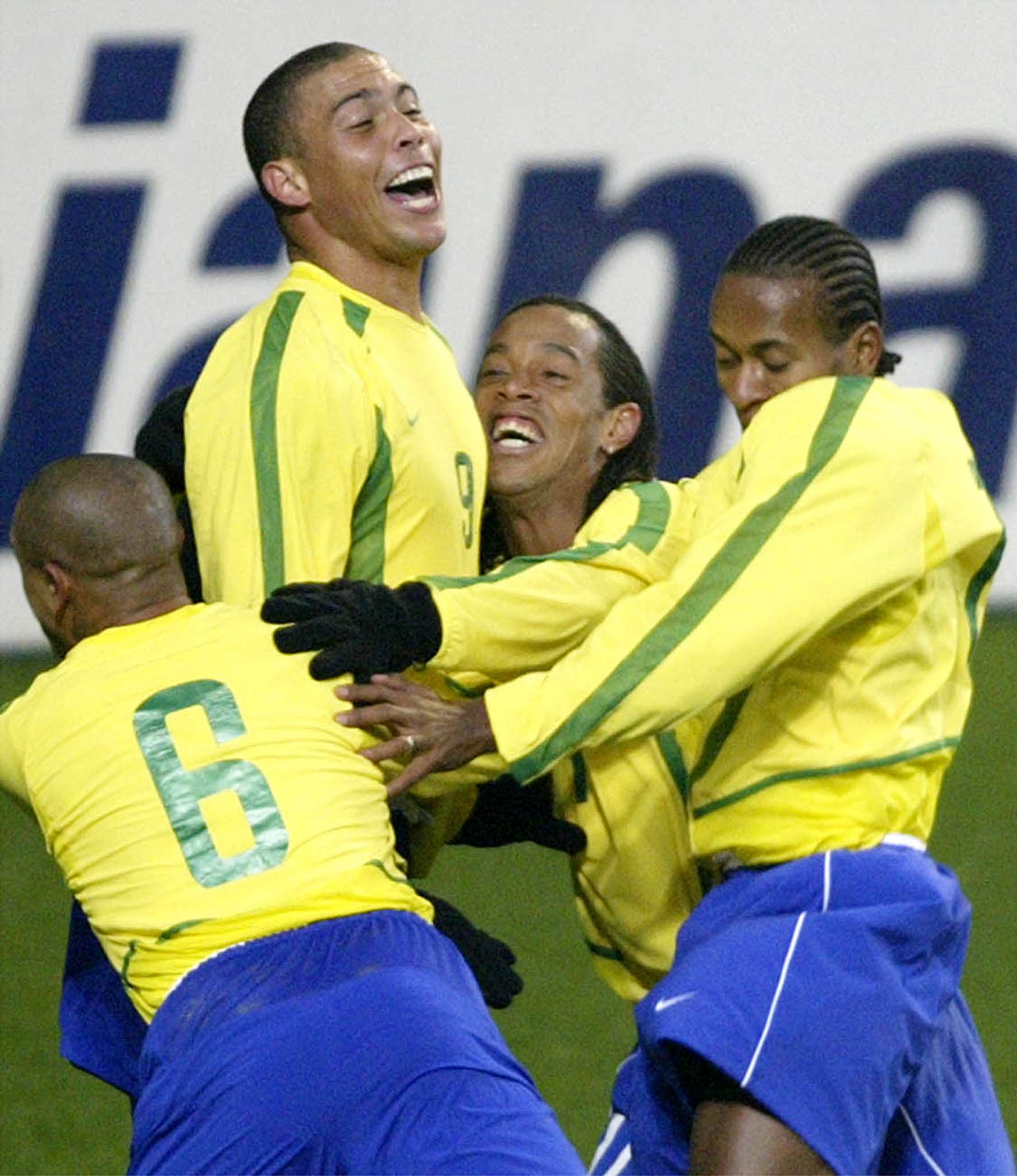 Brazil's Ronaldo (2nd L) celebrates with teammates including Ronaldinho (2nd R) and Roberto Carlos (L) after scoring a goal during their friendly match against South Korea at Seoul's World Cup stadium November 20, 2002. REUTERS/Kim Kyung-Hoon KKH/YN

