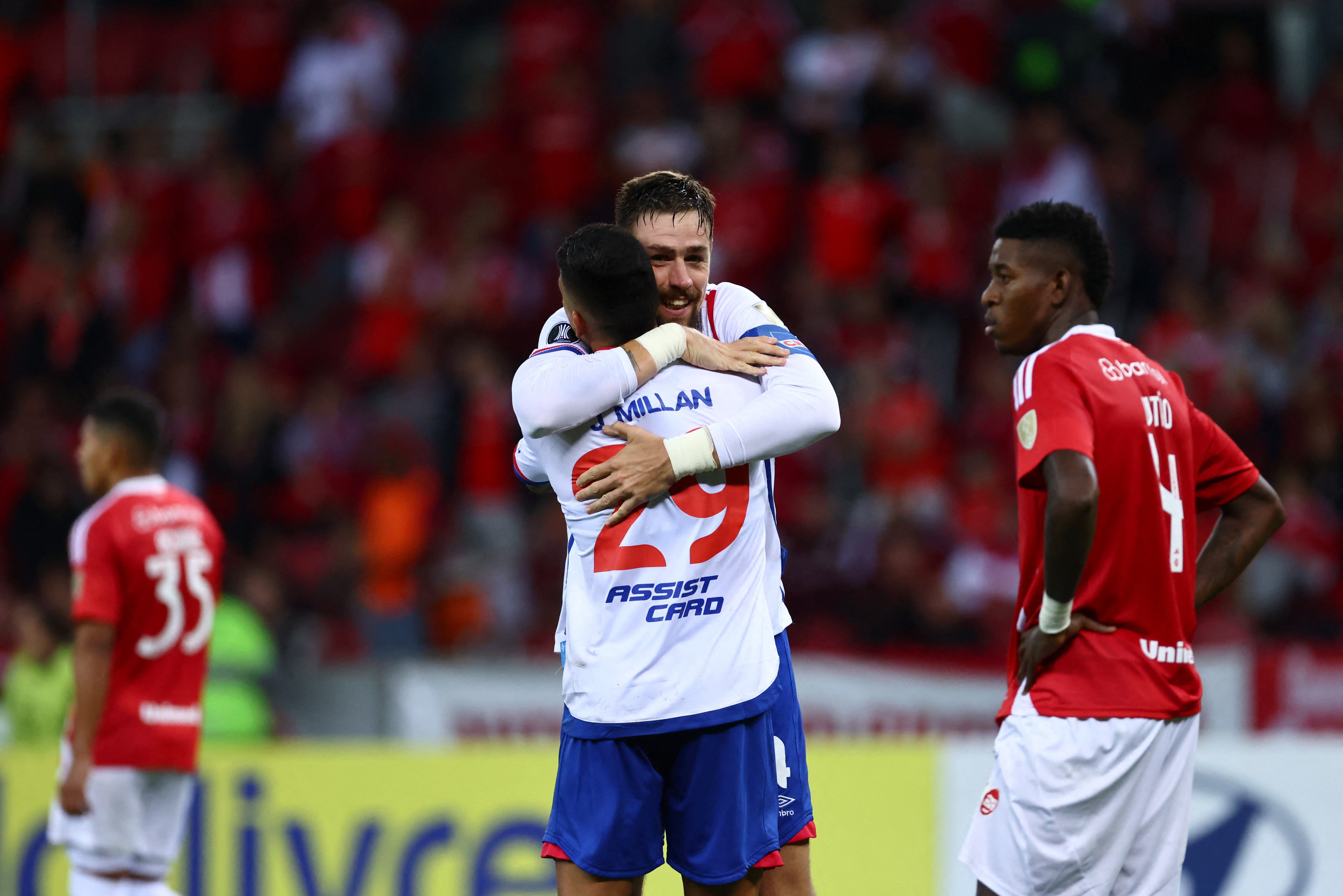 Nacional's Sebastian Coates celebrates scoring their third goal with Julian Millan 