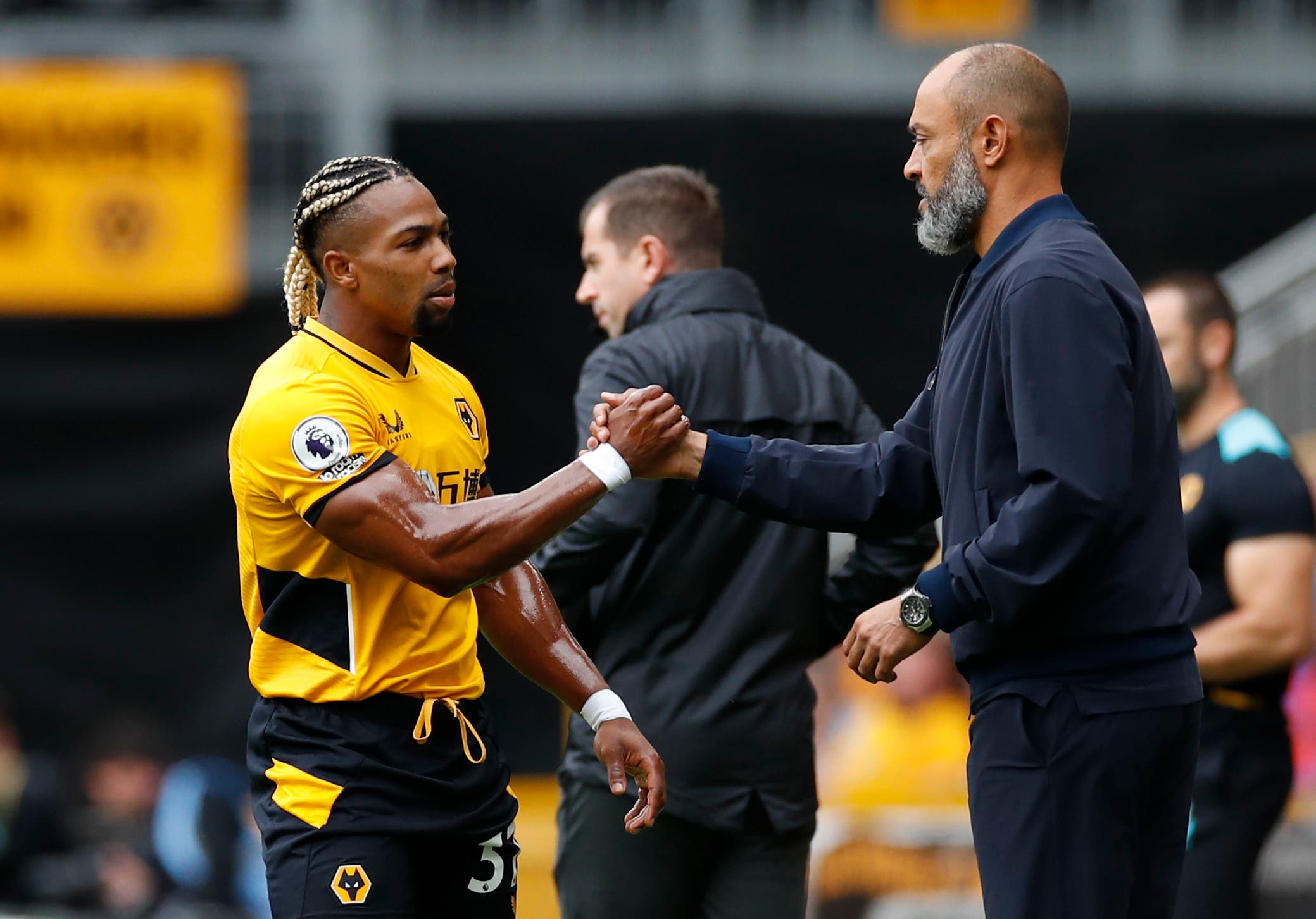 Soccer Football - Premier League - Wolverhampton Wanderers v Tottenham Hotspur - Molineux Stadium, Wolverhampton, Britain - August 22, 2021 Wolverhampton Wanderers' Adama Traore shakes hands with Tottenham Hotspur manager Nuno Espirito Santo before the match Action Images via Reuters/Andrew Boyers EDITORIAL USE ONLY. No use with unauthorized audio, video, data, fixture lists, club/league logos or 'live' services. Online in-match use limited to 75 images, no video emulation. No use in betting, games or single club /league/player publications. Please contact your account representative for further details.