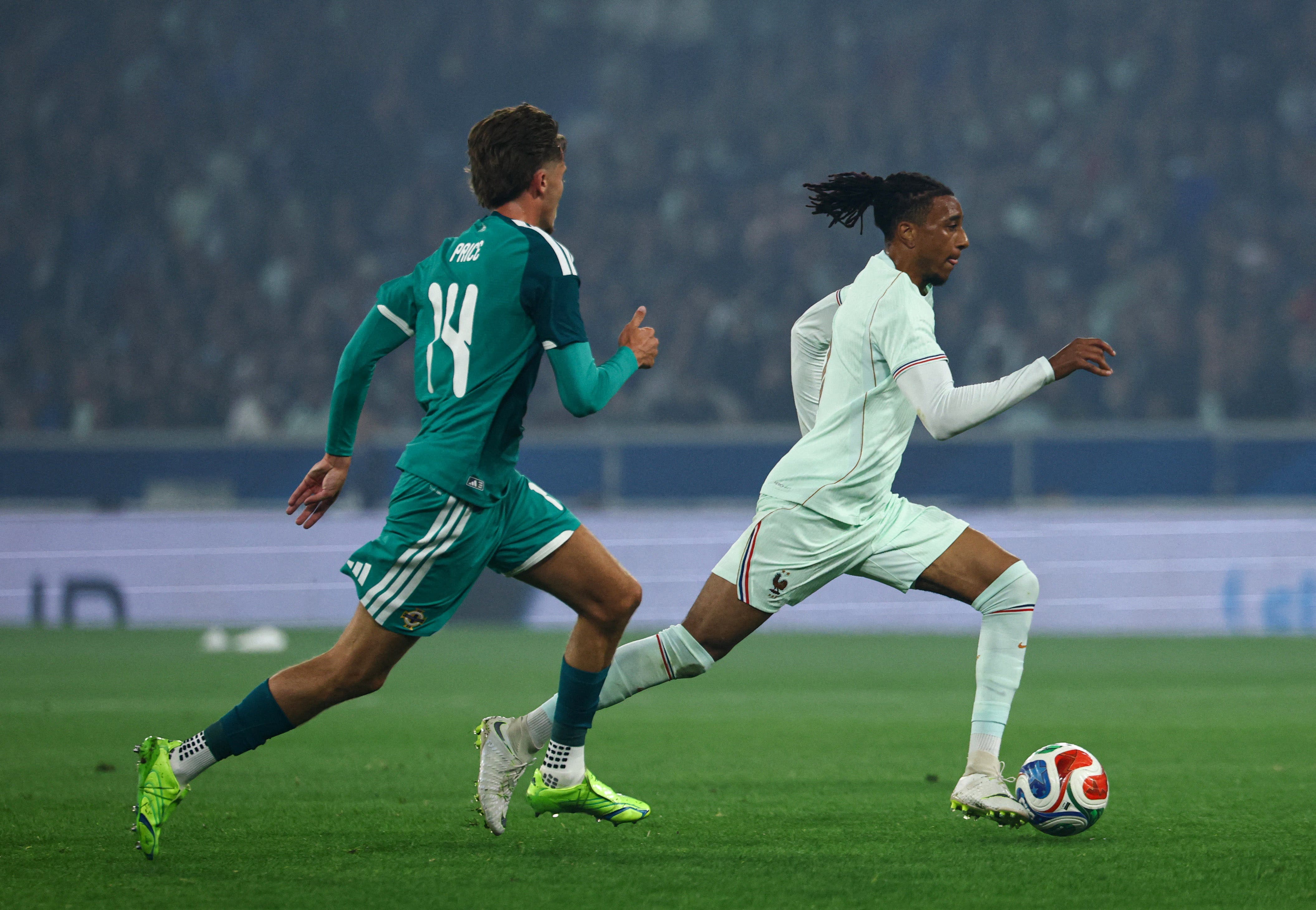 Soccer Football - International Friendly - France v Northern Ireland - Decathlon Arena Stade Pierre-Mauroy, Villeneuve-d'Ascq, France - June 8, 2026 Northern Ireland's Isaac Price in action with France's Michael Olise REUTERS/Sarah Meyssonnier