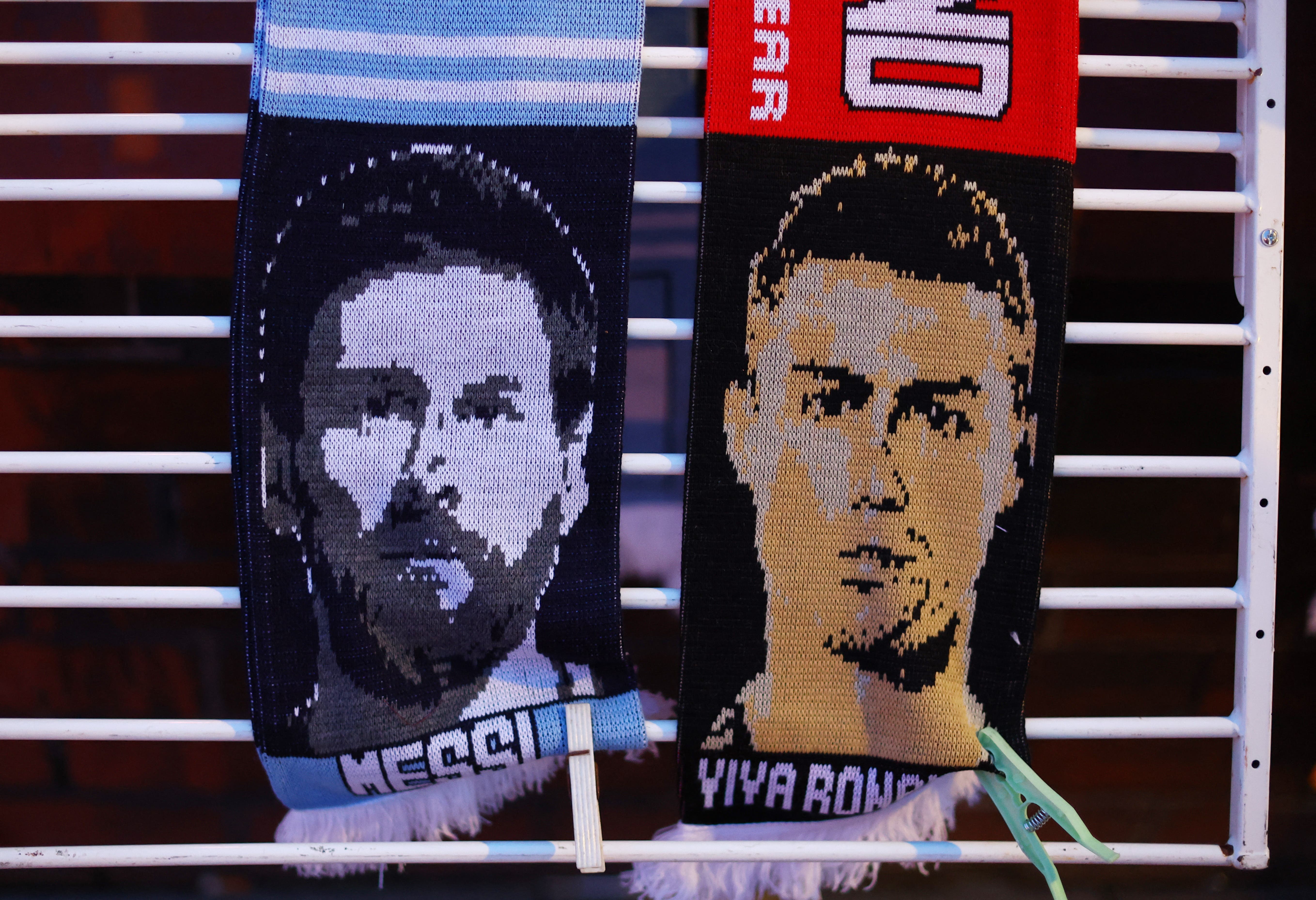 Soccer Football - Europa League - Play-Off Second Leg - Manchester United v FC Barcelona - Old Trafford, Manchester, Britain - February 23, 2023 Former FC Barcelona player Lionel Messi and former Manchester United player Cristiano Ronaldo scarfs are seen outside the stadium before the match REUTERS/Carl Recine