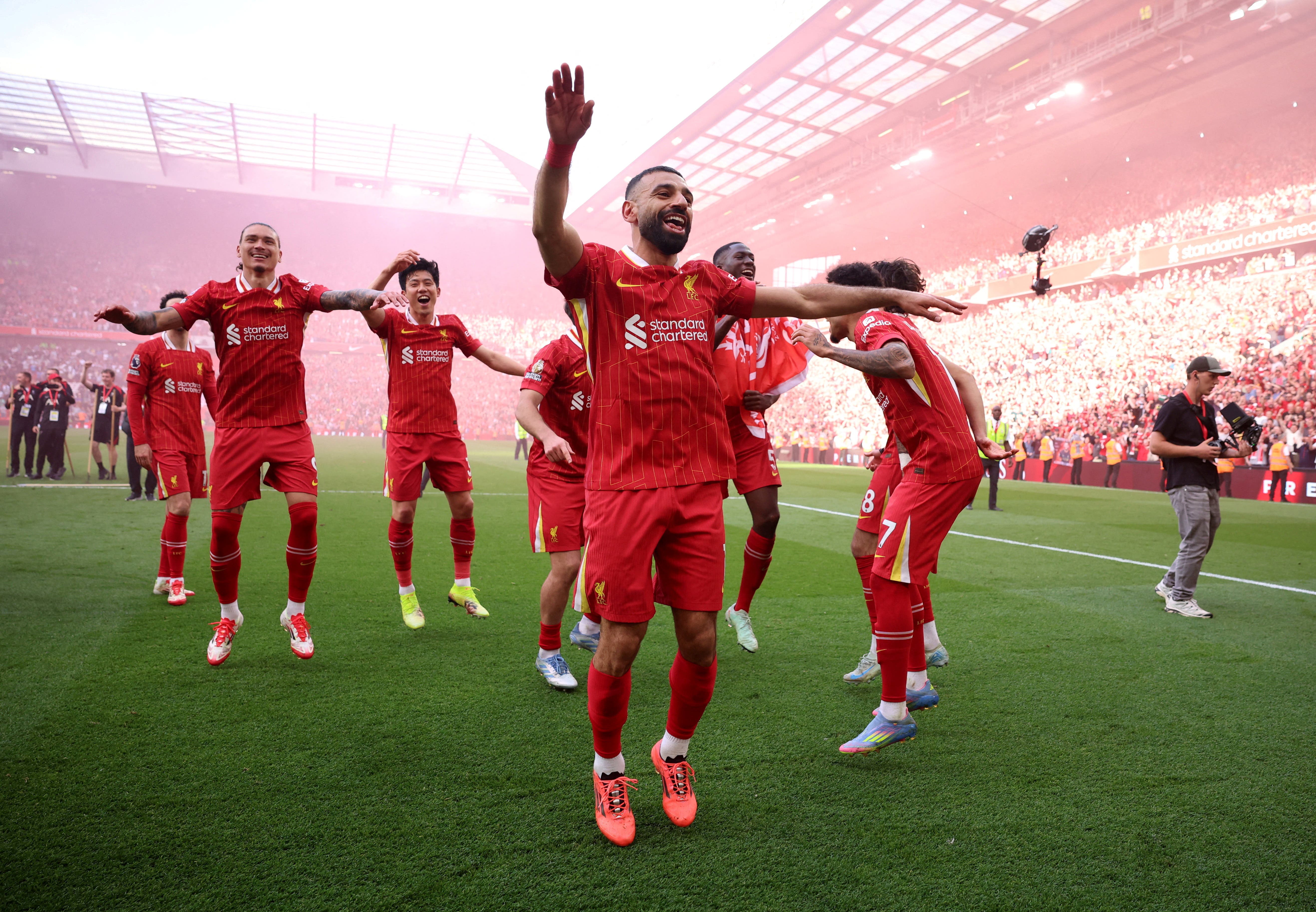 Liverpool's Mohamed Salah and teammates celebrate after winning the Premier League 