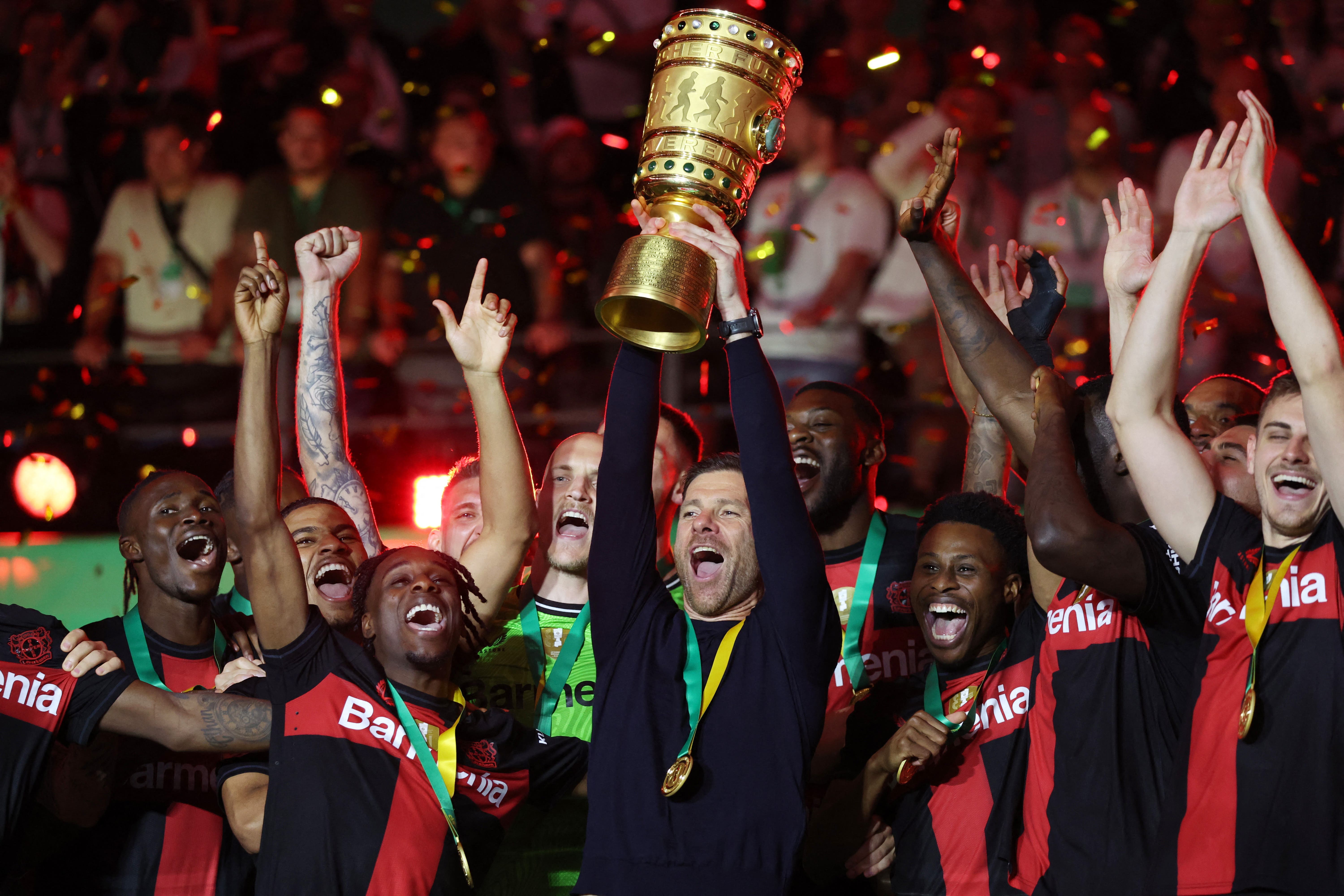Bayer Leverkusen coach Xabi Alonso celebrates with the trophy after winning the DFB Cup