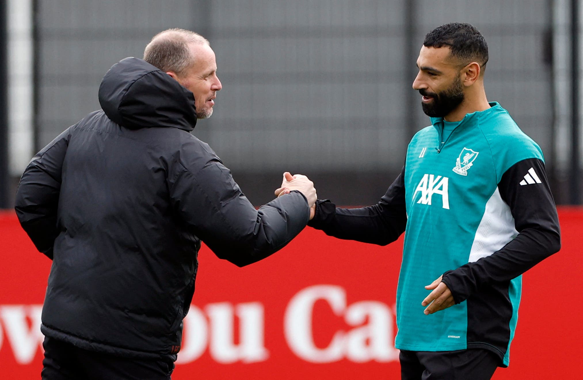Soccer Football - UEFA Champions League - Liverpool Training - AXA Training Centre, Liverpool, Britain - January 20, 2026 Liverpool assistant coach Sipke Hulshoff shakes hands with Mohamed Salah during training Action Images via Reuters/Jason Cairnduff