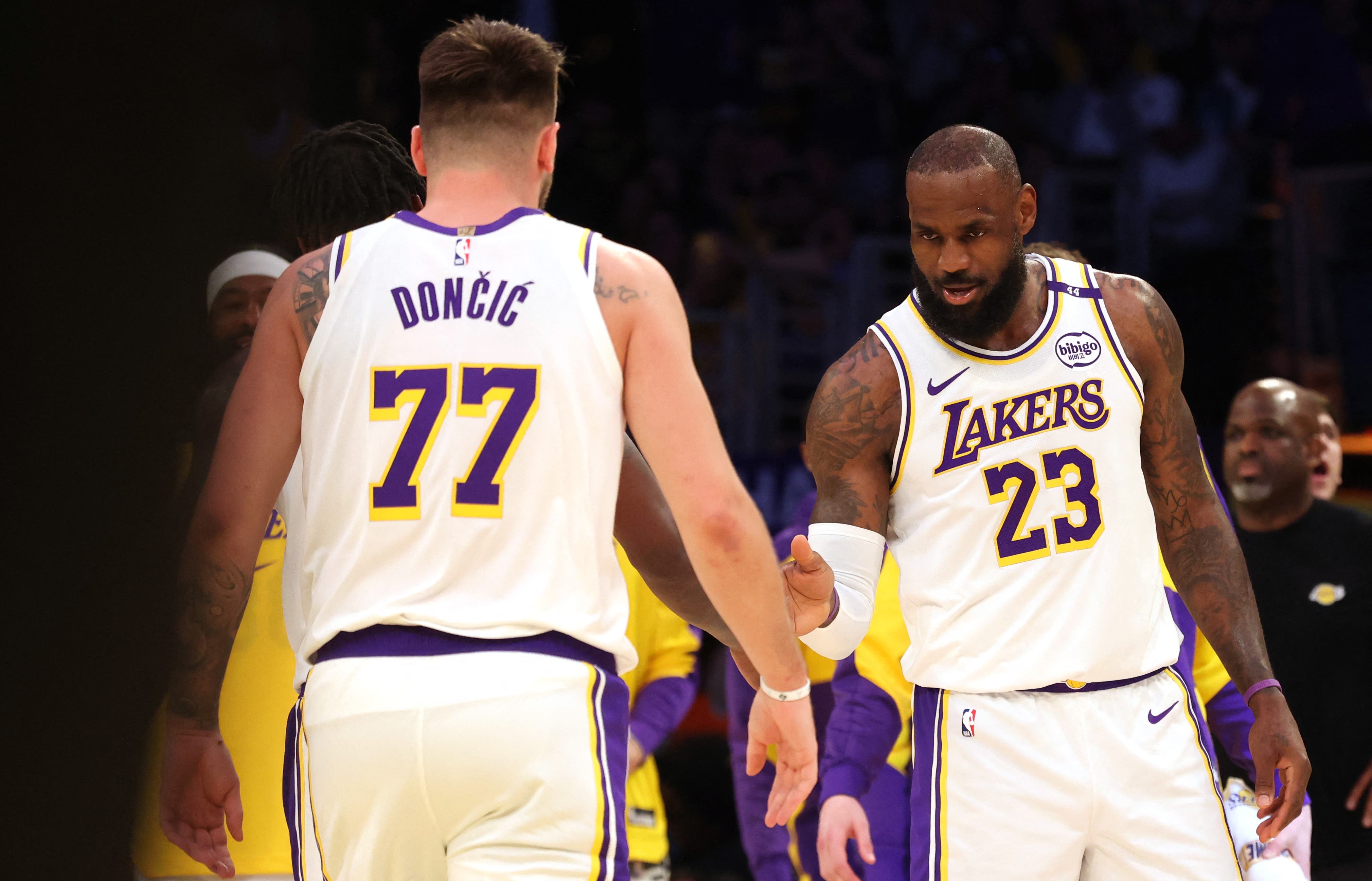 Luka Doncic and LeBron James celebrating for the Los Angeles Lakers.