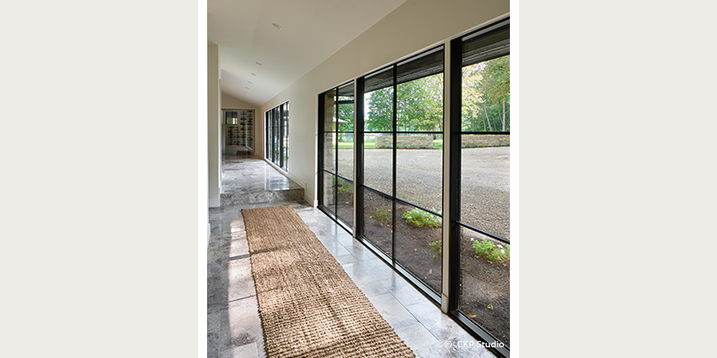customized windows down a walkway in the remodeld home; performance divided lites complements the Kolbe Ultra Series windows and doors throughout the house