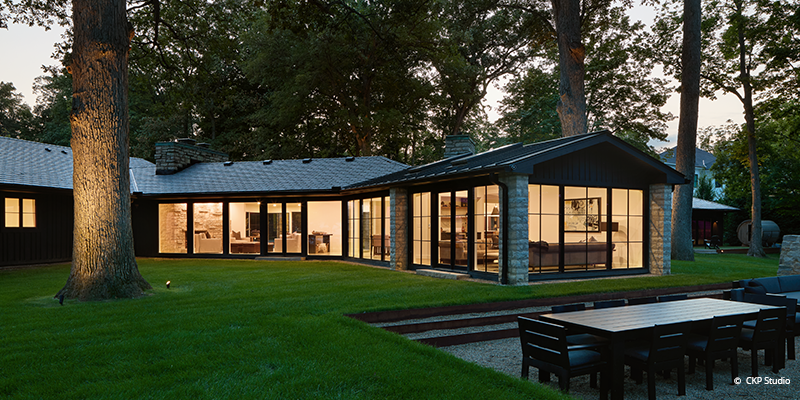Back of the house with large expansive windows and doors