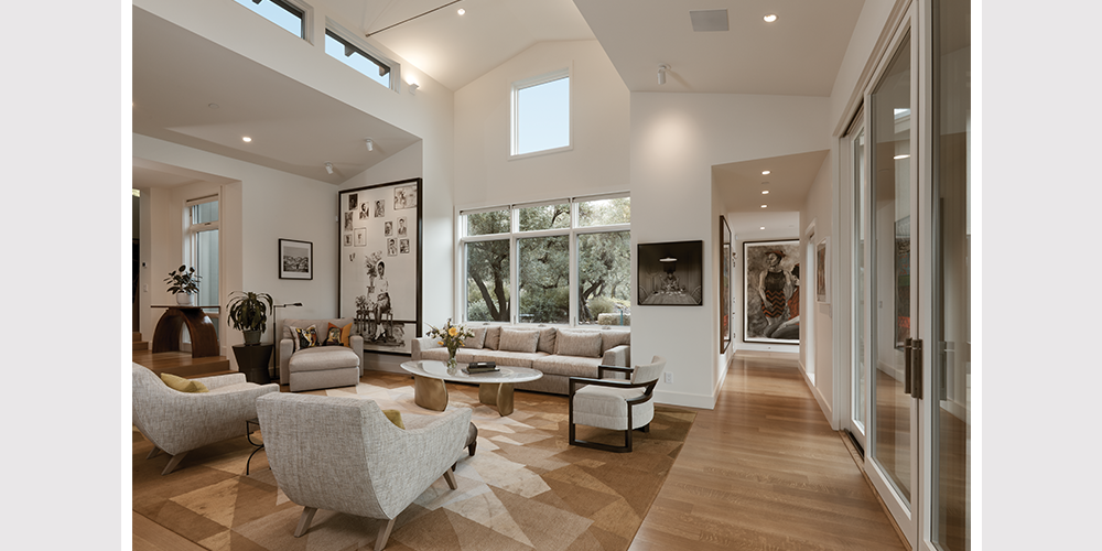 Family room with large direct set windows and windows that accentuate the high ceilings