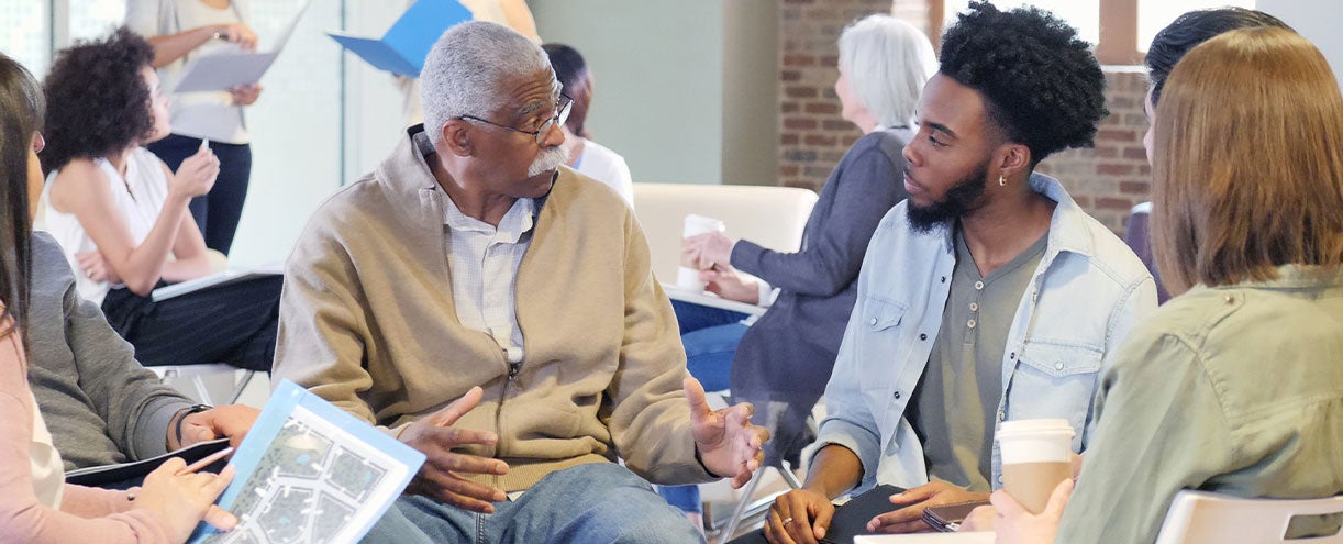 Two men speak at a community event.