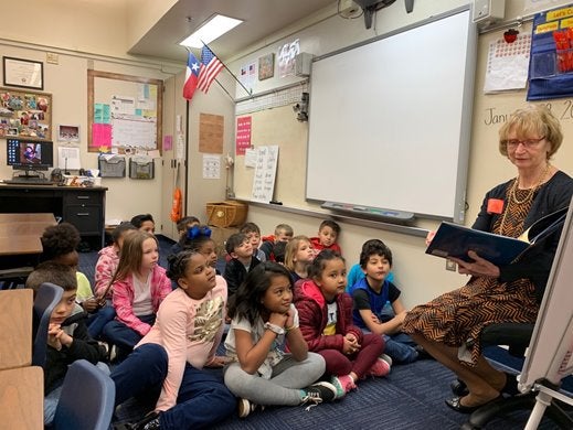Faye Beaulieu reads to a class of students. 