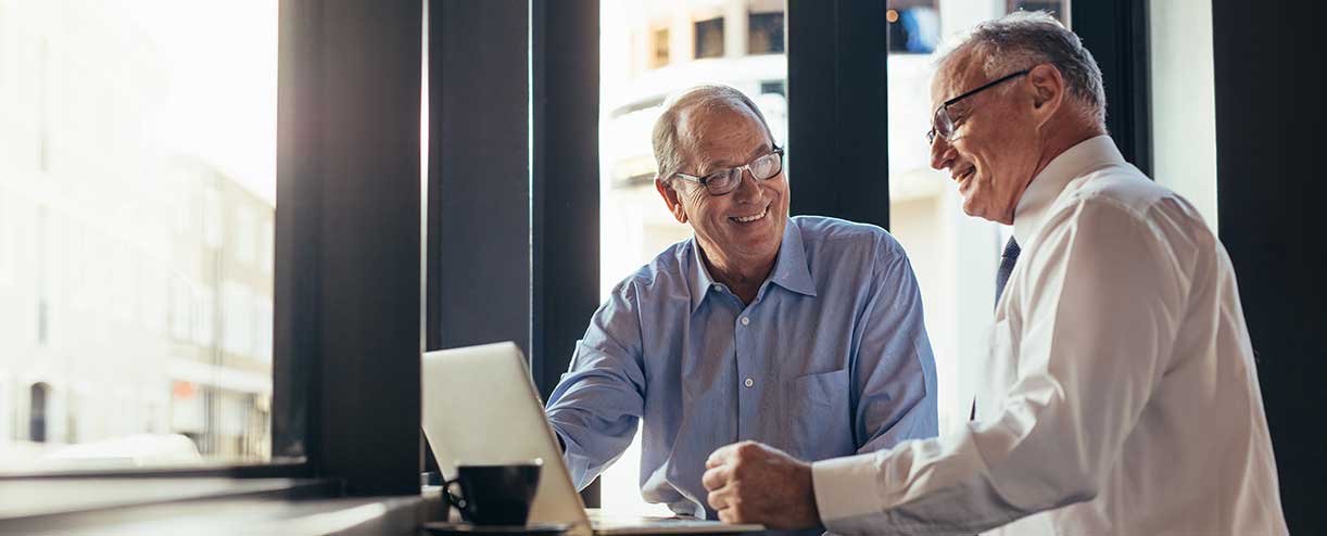 Two businessmen talking in an office.