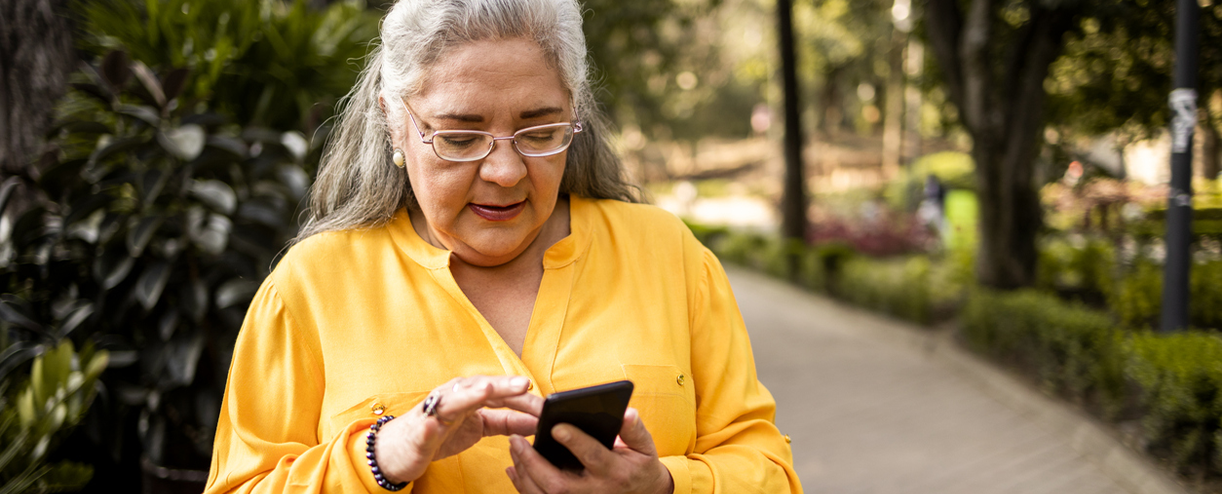 Older woman texting on her phone.