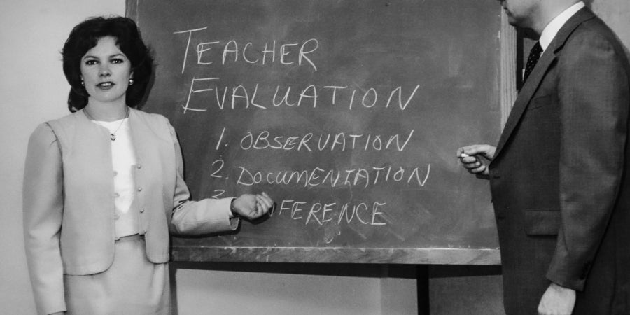 Women in a suit speaks using a chalkboard